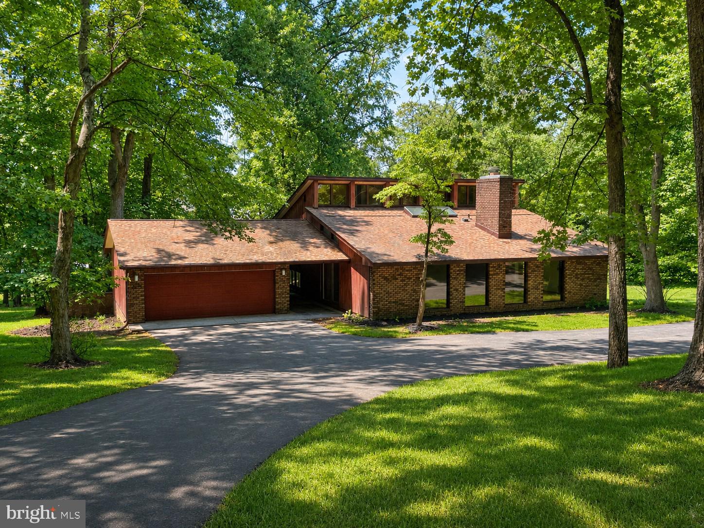 Tired of the typical cookie-cutter home. This beautifully restored Mid- Century Modern home is for you.  No HOA, OAKDALE SCHOOL DISTRICT, and just over three acres of serene privacy.  This home offers an unique open layout on the main level with new LVP flooring, new granite and new appliances.  Just wait until you see the amazing 2-story stone fireplace and the gorgeous dining area.  The upper level offers spacious bedrooms including a primary suite that offers an updated full bath.  Large windows throughout provide an excellent view to enjoy the deer and nature as well as allowing for tons of natural light.  The lower level offers a large living room with walkout access, a half bath and access to the laundry area.  The large partially wooded yard creates a serene space to escape while still only being minutes from Historic Downtown Frederick.  Easy access to shopping, dining, and major commuter routes.