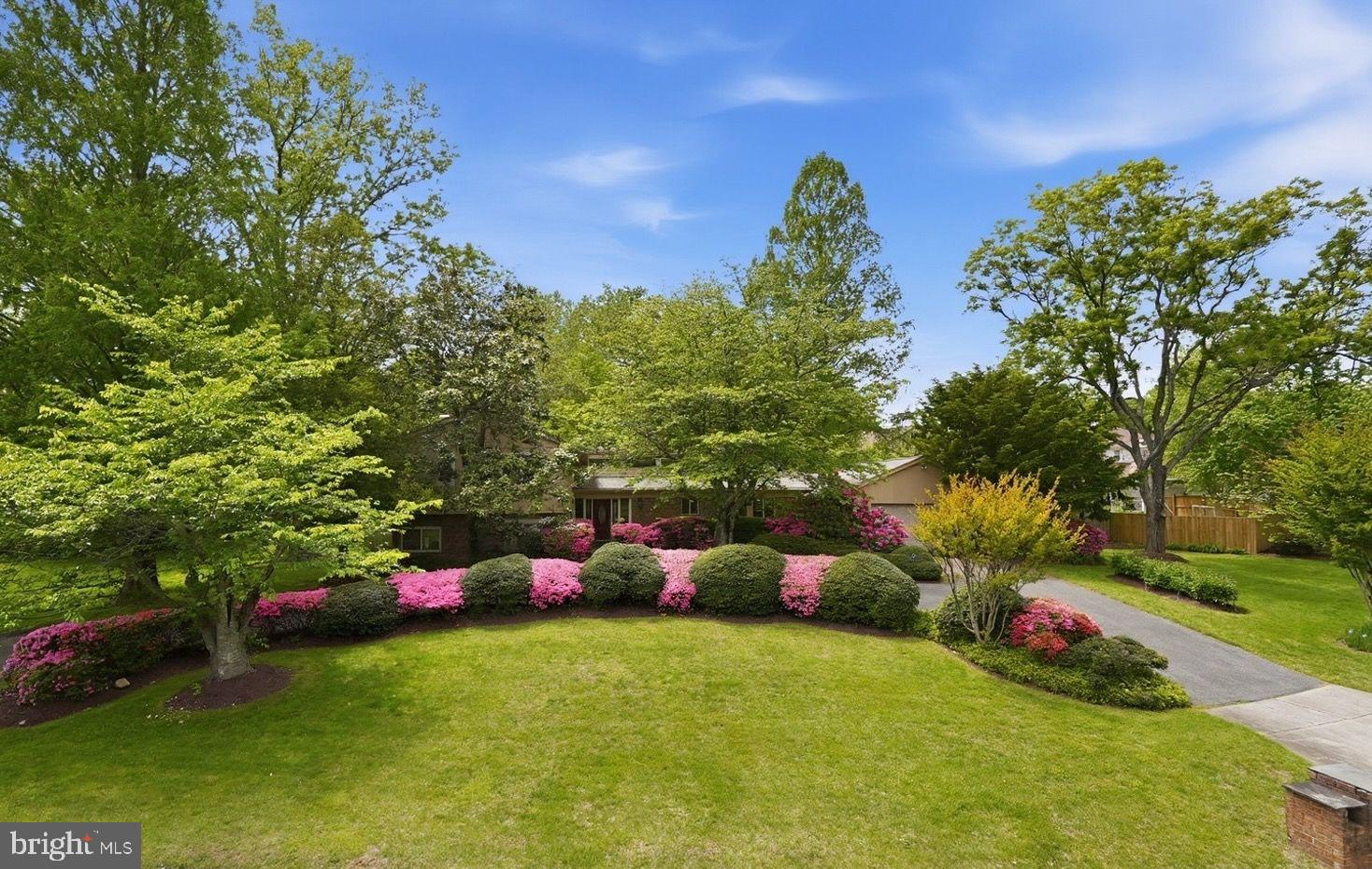NEW ON MARKET! 
Please submit all offers by Tuesday, July 21 at noon.

Enjoy privacy, abundant natural light, and more than half an acre of mature landscaped grounds, all just a pleasant stroll from the shops, restaurants, and conveniences of Potomac Village.

A distinctive custom floor plan places the kitchen at the front of the home, where it overlooks a charming private courtyard. The main level also features a dramatic living and dining room with cathedral ceilings, a circular sunroom that opens to the expansive backyard with a second spacious patio, a convenient main-level laundry room, two powder rooms, and an attached two-car garage.

Upstairs, the generous primary suite offers a skylight, walk-in closet, and en suite bath with four-piece layout. Three additional spacious bedrooms and a hall bath complete the upper level.

Just a few steps down from the main level, you'll find a private fifth bedroom, full bath, and bonus room—ideal for guests, an au pair, or multigenerational living. This level also features a spacious family room with a stone-surround wood-burning fireplace, wet bar, and direct access to the flat, fully fenced backyard. Surrounded by mature landscaping, the outdoor space offers privacy and the feel of a corner lot.

The lower level includes a large recreation room and utility room, providing ample space for recreation, hobbies, storage, or future customization.

Located in the highly regarded Montgomery County Public Schools district, the home is just minutes from Potomac Village, with easy commuter access via River Road and Falls Road. Outdoor enthusiasts will appreciate the close proximity to Great Falls Park and the C&O Canal National Historical Park.

Offering an exceptional location, generous living spaces, and outstanding potential, this home is ready for its next owners to update and make it their own. With great bones and an unbeatable setting, it presents a rare opportunity in one of Potomac's most desirable neighborhoods.