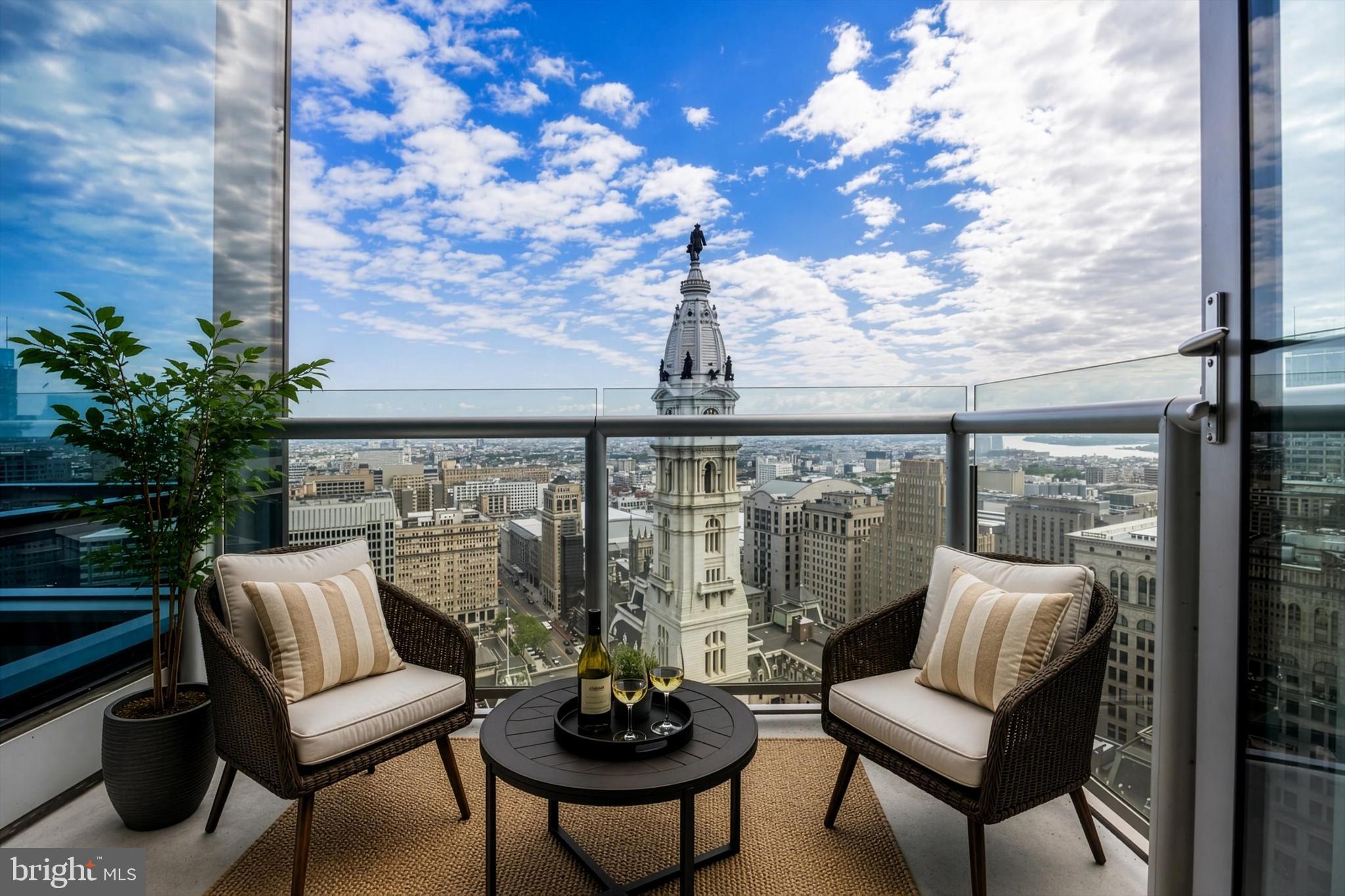 Rising 36 floors above the city, this one-of-a-kind custom residence at The Residences at The Ritz-Carlton offers an unparalleled lifestyle defined by grand proportions and panoramic views. Upon entry through the stately foyer, cherry hardwood floors lead you into a breathtaking great room where floor-to-ceiling glass walls frame an intimate view of City Hall and the Delaware River. The heart of this home is an epicurean’s dream, featuring a chef's kitchen outfitted with gray marble countertops, an oversized social island, and a premier appliance suite including Viking, Sub-Zero, and Miele. A rare custom den with glass walls and French doors provides a sophisticated media retreat, complemented by a butler’s pantry and bar for effortless entertaining. The primary suite is a sprawling sanctuary boasting a sitting area, spectacular northern views, and the ultimate luxury of dual "his and hers" marble bathrooms and independent dressing rooms. Residents enjoy white-glove service and an extraordinary collection of amenities, including a dedicated concierge, chauffeur service, and a state-of-the-art fitness center with a lap pool and yoga room. This offering is made complete with the rare inclusion of two parking spaces. The building also features a residents' lounge, media room, and a gated landscaped park with a 12-foot waterfall and on-site dog run. Luxury extends to hotel-inspired perks like in-residence dining and housekeeping, ensuring a seamless lock-and-leave lifestyle. Perfectly positioned on South Penn Square, you are moments from Philadelphia’s finest landmarks, including Rittenhouse Square, The Union League, and world-class dining like Vetri Cucina and Parc. This is an extraordinary opportunity to experience elevated city living with impeccable service and every convenience at your fingertips.