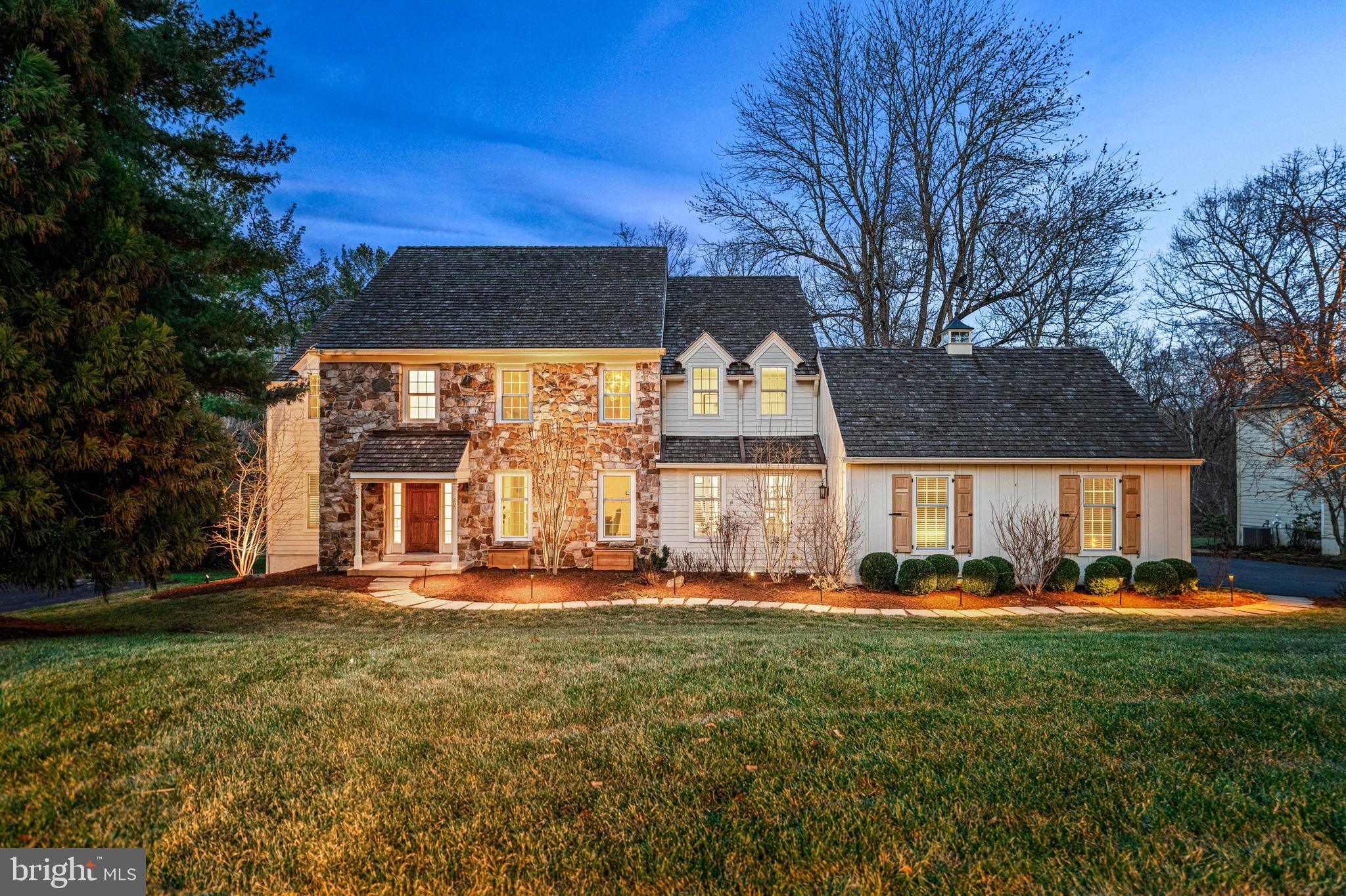 Situated in the sought-after Ravenscliff neighborhood of Radnor Township, this classic 4-bedroom Colonial perfectly balances a private retreat with a connected lifestyle. Nestled on a premier exterior lot backing to a protected preserve space, this property offers privacy and a park-like setting. Finding this level of sanctuary within the award-winning Radnor School District at this price offers a rare opportunity. The home features a fantastic floor plan and is ideally located just minutes from all that Wayne and the Main Line have to offer.
A comprehensive $250,000 exterior renovation delivers exceptional curb appeal! This project included a complete exterior renovation with premium Hardie Board siding. New arched glass paneled doors in the living and great room complement the home’s previous window replacements. The renovation also included professional landscaping and front and rear exterior lighting, alongside the addition of an artisanal Ipe deck crafted with hand-plugged hardware for a flawless architectural finish.
Inside, the two-story foyer opens to a living room with a gas fireplace and arched French doors that draw your eye outside to the Ipe deck—the perfect spot for a morning cup of coffee. This outdoor oasis is positioned to maximize sunlight and shade, providing the ultimate vantage point for preserve views. The setting is further enhanced by a lemon-scented magnolia overhanging the deck and custom lighting that showcases the private grounds.
Across the hall from the living room is a large dining room. Centrally located is a dry bar with cabinetry and counter space. This leads to the home’s heart: an open-concept area combining the kitchen, breakfast room, and great room. Abundant windows make this entire space feel special. The kitchen features white painted Kountry Kraft cabinetry, new quartz countertops, a walk in pantry, and high-end appliances, including a Sub-Zero refrigerator and KitchenAid double ovens. A center island with brand new cooktop and peninsula transition into the breakfast room, where sliders lead to a side patio.The great room impresses with vaulted beamed ceilings and a floor to ceiling custom-paneled fireplace. French sliders open to the deck, where stairs lead to the private yard, ideal for backyard games with family and friends.
The combined mudroom/laundry is remodeled and expanded for maximum organization, featuring gorgeous tile and access to the two-car garage enhanced with epoxy flooring. Off the foyer, a private office features custom built-ins. A powder room and hall closet complete this floor.

Upstairs, a show stopping primary suite boasts a completely remodeled bedroom and ensuite bath. This marble-clad home spa feels like a five-star retreat, featuring a large walk-in shower with bench seating and a soaking tub with views. High-end finishes include a double-sink vanity, marble floors, glass cabinetry, seamless shower glass and door and a separate water closet. A large walk-in closet with a window completes this private sanctuary. Down the hall, three additional large bedrooms—some with custom built-in closets—completely redone hall bath featuring a double vanity, gorgeous built-in cabinets, herringbone tile, and a marble shower.

The unfinished walk-out lower level offers expansion possibilities. The home offers a whole-home generator, newer high-efficiency HVAC, two brand-new hot water tanks, and an updated electrical panel.

205 Ravenscliff Road offers rare tranquility without sacrificing convenience. Positioned one mile from downtown Wayne’s shops, dining, and rail (18 minutes to Center City), you are also moments from the scenic Willows, Chanticleer Garden, and the Radnor Trail. Set in the top-rated Radnor School District, just 30 minutes from the airport and minutes from premier private schools and country clubs. A true sanctuary effortlessly connected to the best of the Main Line.
