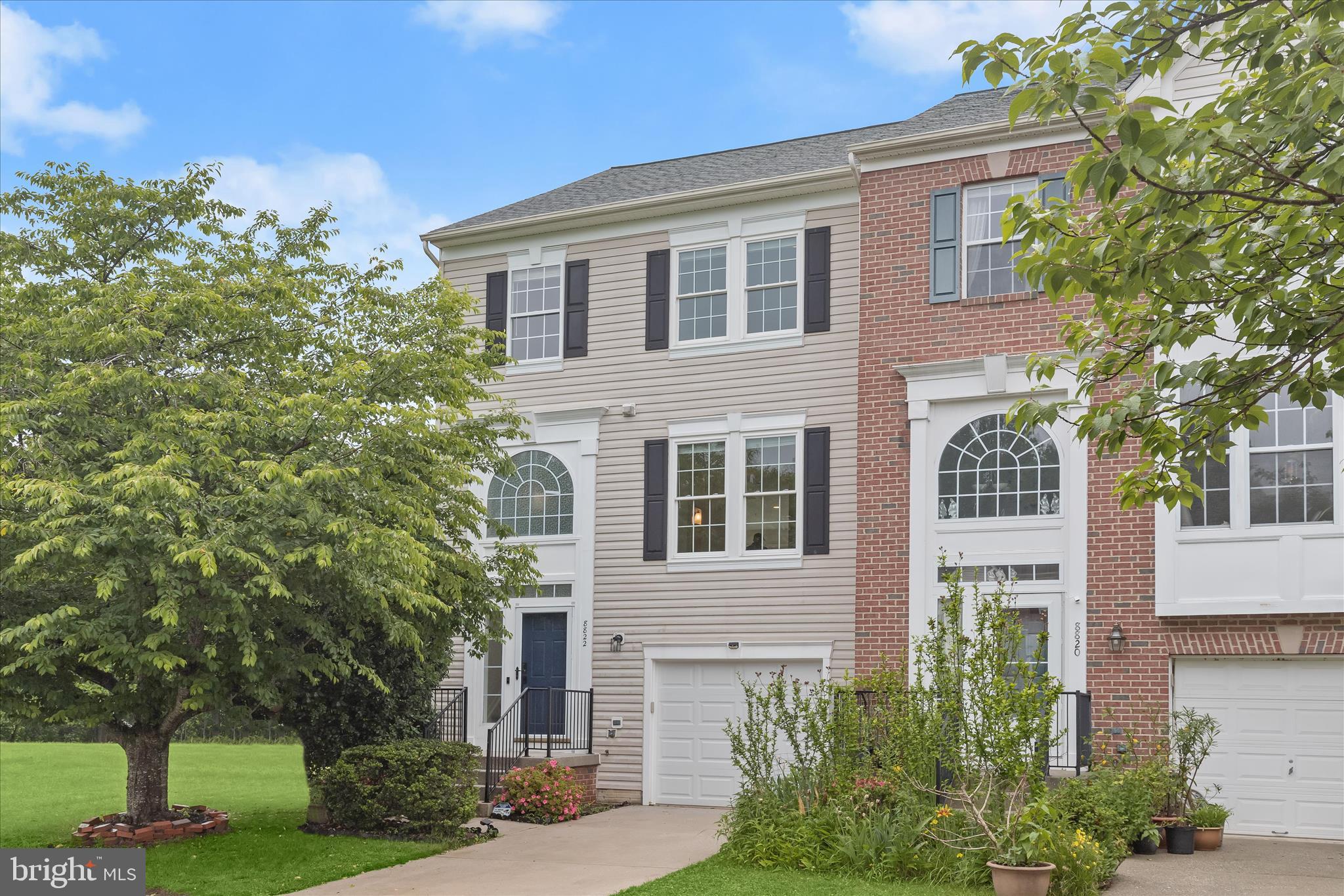 Spacious end-of-row townhome in sought-after Ellicott City, backing to a serene reserve with beautiful tree-lined views. Freshly updated with new flooring and fresh paint throughout, this light-filled home offers an open and inviting floor plan designed for comfortable everyday living and entertaining.  A dramatic two-story foyer welcomes you inside and opens to the living room featuring gleaming hardwood flooring. The updated kitchen is the heart of the home, showcasing granite countertops, a center island, white cabinetry, and stainless steel appliances. The kitchen flows seamlessly into the dining and family room areas, with sliding glass doors providing access to the expansive deck overlooking the private wooded backdrop.  Upstairs, the spacious primary suite offers a soaring vaulted ceiling, walk-in closet, and a luxurious en-suite bath complete with a soaking tub, dual-sink vanity, and separate shower. Two additional generously sized bedrooms and a full hall bath complete the upper level.  The walkout lower level features a large recreation room anchored by a cozy brick fireplace, a convenient laundry area, and sliding glass door access to the patio and fenced backyard, perfect for relaxing, entertaining, or enjoying the peaceful natural setting.  Ideally located near major commuter routes, shopping, dining, parks, and entertainment, this beautifully maintained townhome combines spacious living, modern updates, and a highly desirable Ellicott City location.