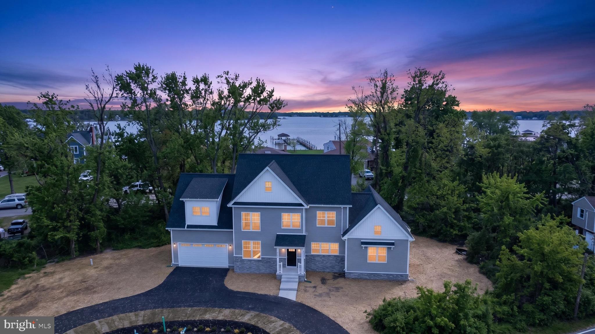 Beautiful new construction home located in the heart of the Poplar Ridge Peninsula.  Enjoy breathtaking water views from every angle.

The kitchen features beautiful quartz countertops, an island with seating, an abundance of cabinetry and counter space, and a spacious walk‑in pantry. Thoughtful upgrades throughout the home include a pot filler (convenience at its best!) and many additional extras.

This exceptional property offers dual primary bedrooms, each with a private ensuite bath—one on each level—both providing private outdoor access to relax and enjoy the peaceful sounds of the water.  The brick fireplace serves as a striking focal point in the main living area, perfect for cozy evenings.
The upper level boasts a spacious bonus room, and laundry access is available on both floors for added convenience. Take in the spectacular water views from the upper‑level balcony or the main‑level deck. 
A circular driveway adds ease and convenience for guest parking.   Even added a car charging outlet in the  oversized 2 car garage. 
This truly is a must‑see home, offering countless upgrades and special features you need to experience in person.

Poplar Ridge Community Association