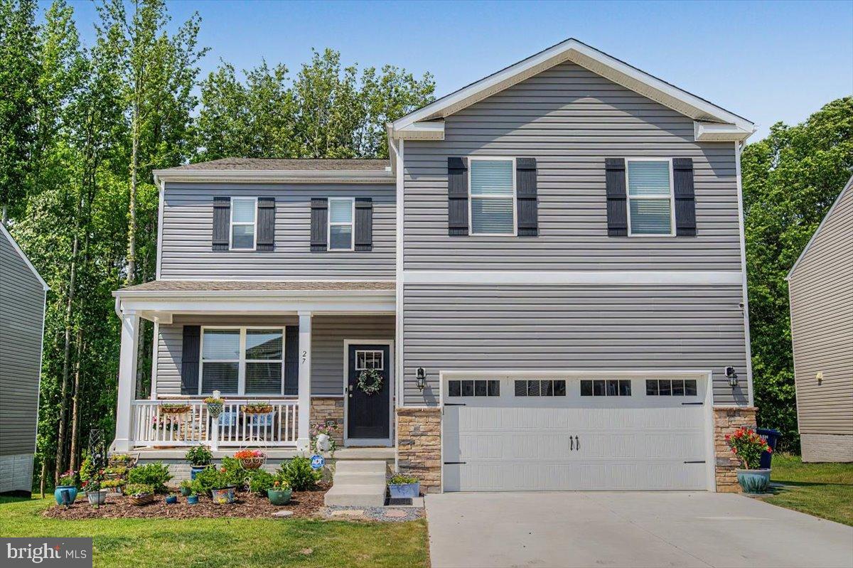 2 years young Galen model—exceptionally maintained and lightly lived in. Ideally situated seconds from Delaware and minutes to downtown Newark, this home offers the rural charm of Cecil County with easy access to urban conveniences. A professionally landscaped yard and welcoming front porch set the tone on arrival. Inside, an elegant, open-concept living area flows to the kitchen, anchored by a large island ideal for casual dining and entertaining. The kitchen features quartz countertops, a glass cooktop, stainless appliances, a walk-in pantry, and a stylish backsplash. Main level amenities include a convenient powder room and direct access to a cozy rear deck that overlooks a substantial wooded buffer—perfect for privacy and outdoor enjoyment. The upper level offers four generously proportioned bedrooms; the primary suite includes a large walk-in closet and an en suite with a walk-in shower and double vanity. An upstairs laundry room provides ample space and shelving for convenience. The lower level is finished with an additional living area, a bedroom with egress, a full bath, and abundant storage. With nearly new appliances and systems throughout, this home provides move-in readiness and years of low-maintenance living.