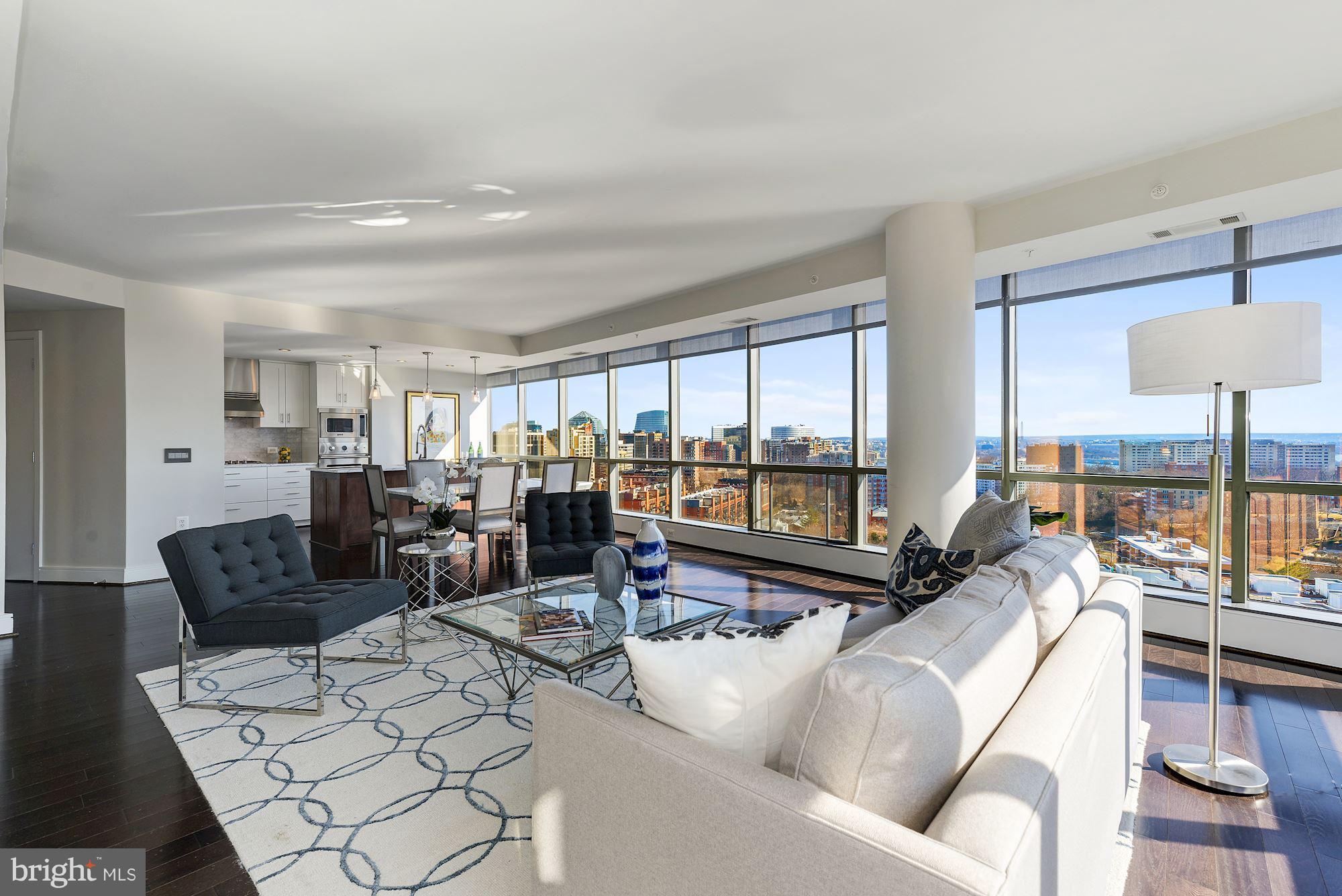 Penthouse style living in The Odyssey, one of Arlington's premier condo buildings. Stunning 180-degree views of DC skyline plus new finishes, custom cabinetry, Calacatta Statuaryo marble counters, Grohe faucets, & top-of-the-line appliances. Features 2 balconies, 2 garage parking spaces, & 2 storage units. Full-service building with fitness center, rooftop pool, & concierge. 2 blocks to Metro!