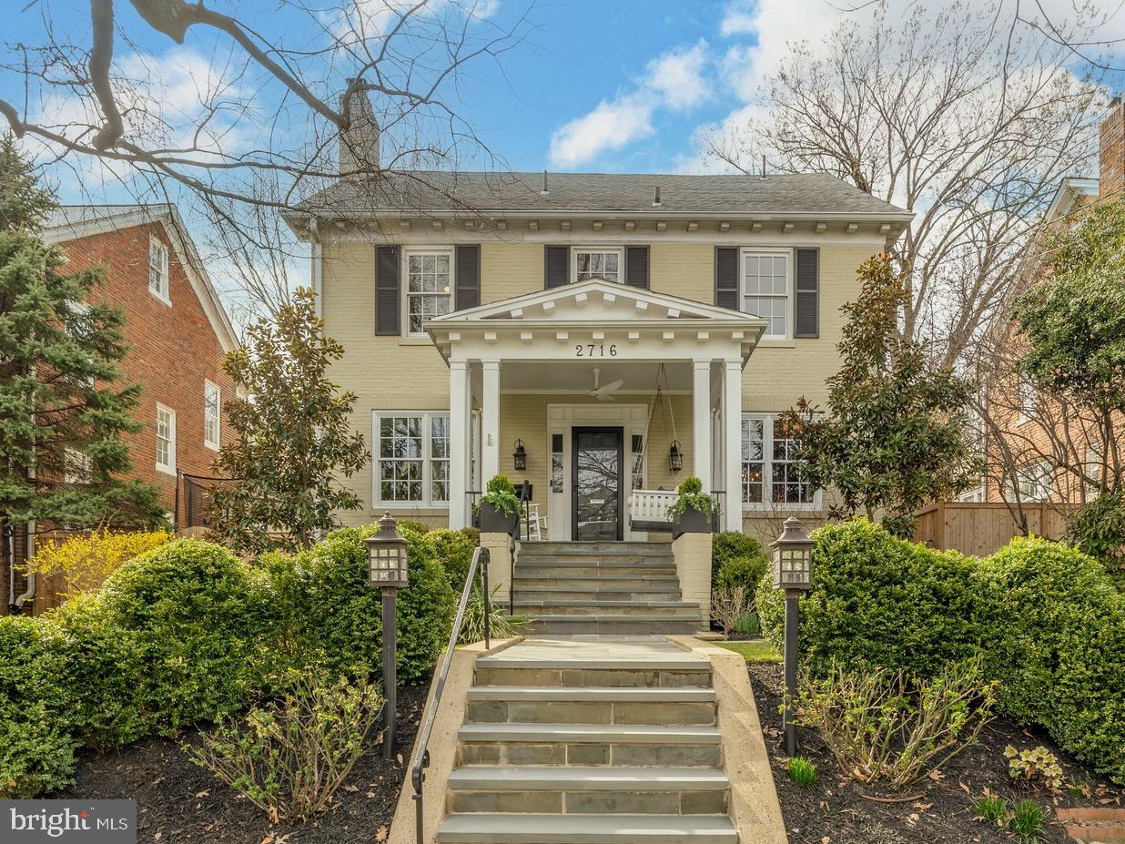 Timeless elegance meets modern comfort in this beautifully reimagined 1925 center-hall Colonial, offering six bedrooms, four and a half baths, and over 4,800 square feet of refined interiors. Perfectly positioned on a lush lot on a picturesque, tree-lined street in Observatory Circle, this home captivates from the start with its classic architecture and charming front porch—an inviting prelude to its gracious interiors.
Inside, exquisite architectural details abound, including elegant millwork, high ceilings, rich wood floors, arched doorways, and two fireplaces. The main level seamlessly blends formal and casual living, featuring a grand foyer, a sophisticated living room, a formal dining room, and a sunlit family room that opens to the chef’s kitchen. Designed for both function and style, the kitchen boasts a Wolf gas range with venting hood, custom cabinetry, generous counter space, and ample storage. A butler’s pantry/wet bar enhances the space, perfect for entertaining, while a well-appointed mudroom with custom built-ins adds everyday convenience. A powder room completes this level.
French doors lead to a beautifully landscaped rear yard, designed for outdoor enjoyment with a stone terrace, 86” outdoor TV, built-in speakers, a gas line, a motorized awning, and a sport court.
Upstairs, the luxurious primary suite occupies a private wing, complete with a sitting room, a spacious bedroom, a custom walk-in closet, and a marble-clad en-suite bath. Three additional generously sized bedrooms and two bathrooms complete this level. The third floor offers two more bedrooms and a full bath, providing flexibility for guests, office space, or a private retreat.
The finished lower level expands the home’s living space with a large recreation room, a gym/flex space, and a mechanical/laundry room. A detached two-car garage completes this exceptional offering.
Nestled on a serene, tree-lined street in Observatory Circle, this home offers easy access to top-rated schools and the city’s best shopping and dining. A rare blend of historic charm and modern luxury, this is a home to cherish for generations.