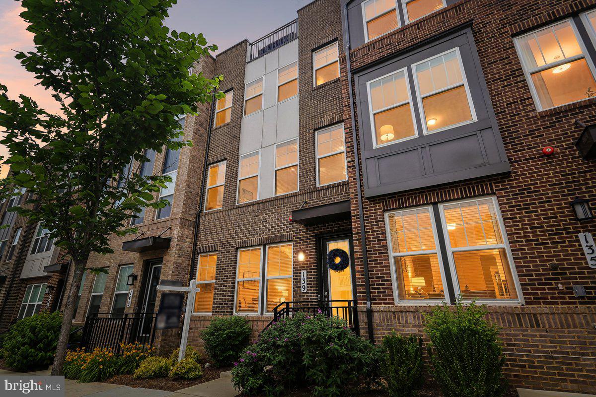 Like new and only four years young, this stunning four-level townhome offers exceptional flexibility, modern finishes, and multiple indoor and outdoor living spaces.

Upon entry, you'll find a spacious open room accompanied by a full bath, creating the perfect opportunity for a guest suite, fourth bedroom, home office, fitness room, or additional living space.

The main level is designed for both everyday living and entertaining, featuring a beautiful center kitchen that serves as the heart of the home. Designated living and dining spaces flow seamlessly around the kitchen, while a large deck just off the kitchen extends your living space outdoors, perfect for grilling, dining ,or simply relaxing. A convenient half bath is also located on this level.

The third floor offers three bedrooms, including a spacious primary suite with a beautiful ensuite bath and generous closet space.

Continue to the top level where you'll discover another grand open space with endless possibilities. Whether used as a family room, media room, home office, or guest retreat, this versatile area opens directly to a fabulous rooftop terrace, providing the perfect setting for entertaining or enjoying the outdoors. An additional half bath on this level adds convenience.

Only four years old, this thoughtfully designed home combines modern style, flexible living areas, and exceptional outdoor spaces to create a truly special offering.

Located in vibrant Downtown Crown, you'll enjoy a truly walkable lifestyle with restaurants, shops, fitness studios, grocery stores, parks, community events, and entertainment just steps from your front door. Combining modern design, flexible living spaces, and an unbeatable location, this exceptional home offers the very best of Crown living.
