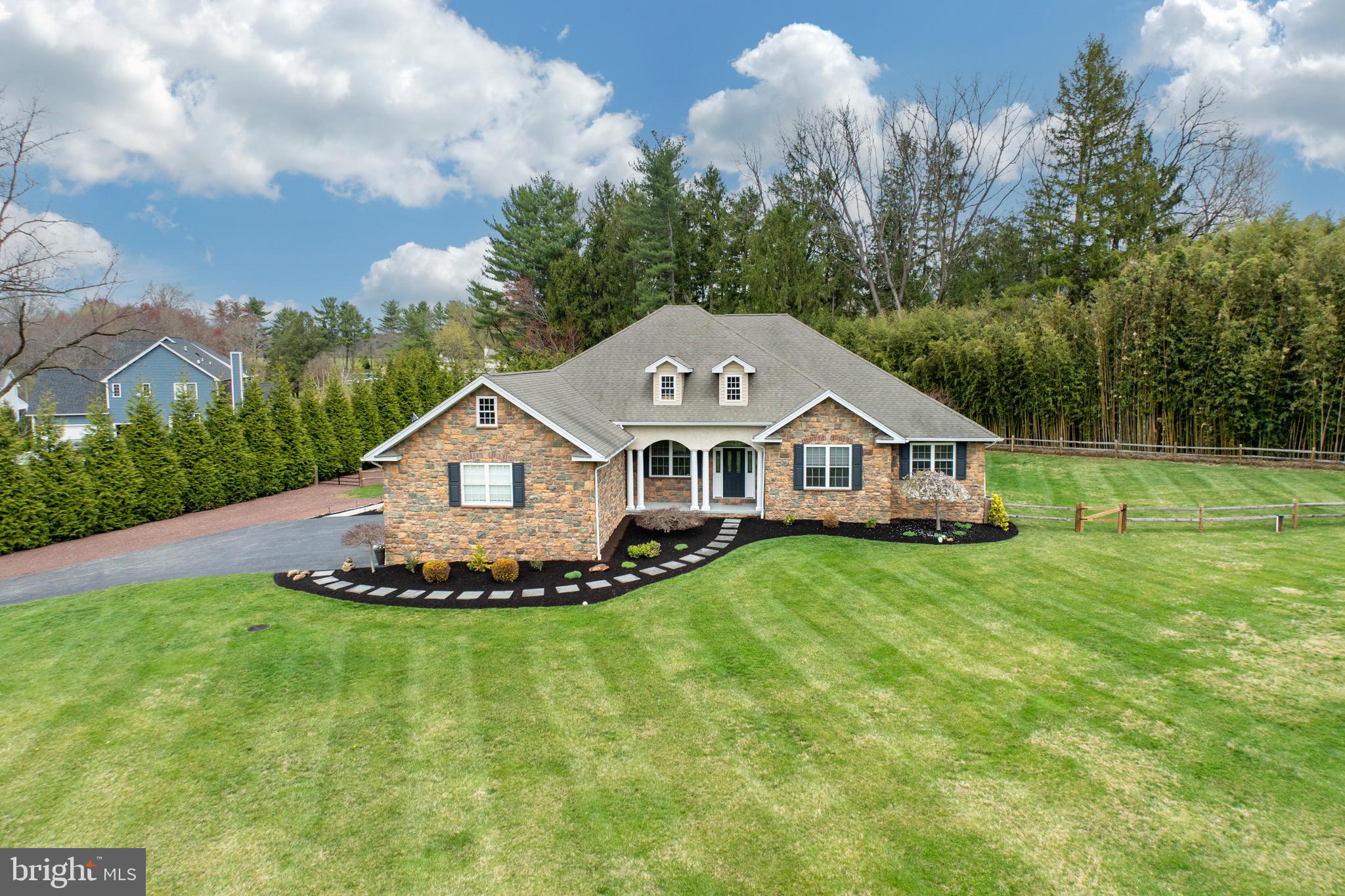 Welcome to this elegant ranch-style home, nestled on a beautifully landscaped private, flat acre+ lot in one of East Goshen’s most desirable locations. This exceptional residence blends timeless charm with modern luxury, offering a bright, open floor plan ideal for both relaxed living and stylish entertaining.
Step through the front door and you’re immediately welcomed by gleaming hardwood floors, detailed moldings, and a sunlit, inviting interior. At the heart of the home is a gourmet kitchen, thoughtfully designed for everyday living and entertaining alike. It seamlessly opens to a spacious great room, anchored by a gas fireplace and French doors that lead to a tranquil outdoor patio, ideal for indoor-outdoor gatherings.
A formal dining room, is gracefully set off of the great room, adds a touch of sophistication and opens to the entry foyer. The luxurious first-floor spacious primary suite offers a private sitting area, French doors to the patio, and ensuite bath featuring a large walk-in shower, Jacuzzi tub, and a dual vanity. 
Two additional, generously sized bedrooms share a full hall bath.  The laundry room is conveniently located on the first floor enhancing everyday functionality. In addition to a well designed first floor - the custom-finished basement adds incredible versatility and space - delivering the fourth bedroom with a full bathroom, bar area, home gym, and additional recreation space—perfect for additional living space, entertaining, or a private in-law suite. This rare offering on a peaceful setting is completed by an oversized 3-car garage, fenced in backyard and is conveniently located to Paoli Pike, Route 202, Downtown West Chester and East Goshen Park! Showings will begin on Friday 4/11.