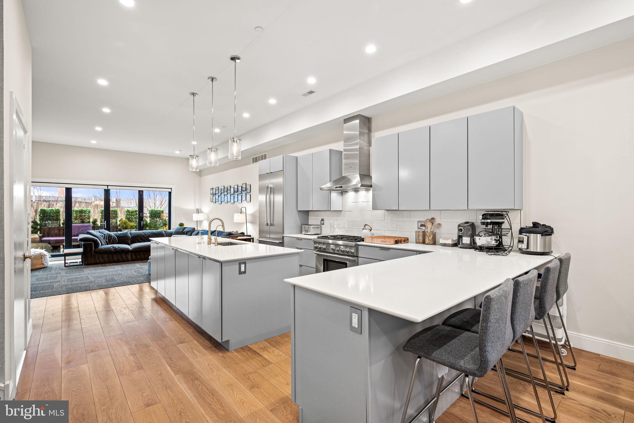 Welcome to 4588 Silverwood Street, a stunning 3,297 sq ft contemporary residence designed by Canno Architecture. This 3-bedroom, 3.5-bath luxury townhome with 5-stop elevator and 2-car attached garage offers refined design, dramatic architectural details, and exceptional indoor-outdoor living in the heart of Manayunk.

A striking custom window wall façade sets the tone for the home’s light-filled interior. The main living level features 11-foot ceilings, wide-plank hardwood floors, recessed lighting, and entire rear wall of La Cantina Accordion style glass doors leading to a deck seamlessly blending the interior with the exterior space. The open-concept layout includes a spacious dining area with seating for 10, sleek chef’s kitchen with Thermador appliance package, six-burner gas range, two oversized islands (one with seating and the other with storage), a wine refrigerator, and abundant cabinetry. The living room showcases a linear gas fireplace, floating shelving, built-in bar area just inviting you and your guests into this serene and welcoming space. 

The entire second floor is dedicated to the primary suite retreat with 10-foot ceilings, floor-to-ceiling windows, dual custom walk-in closets, and a spa-inspired bath featuring two vanities, separate water closets, oversized frameless glass shower, soaking tub, and European finishes by Porcelanosa. 

The third level offers two additional bedrooms with large walk-in closets, two full baths with modern finishes, and a spacious laundry room with full-size Samsung appliances and custom cabinetry.

The pilot house includes a wet bar and wine refrigerator, leading to a two-sided rooftop deck with city views, owner installed wooden hot tub, and mature urban edible garden to grow your favorite herbs and vegetables! 

The lower level provides direct interior access to the 2-car garage (plus third parking space outside), oversized coat closet, and a versatile bonus room currently outfitted as a gym with sauna to enjoy after your workout!

Additional features include tankless hot water heater, Icynene spray foam insulation, high-efficiency dual Carrier HVAC systems, Ecobee thermostats, green roof, and remaining 2 year tax abatement. Conveniently located with easy access to Center City, transportation, highways, and the suburbs.