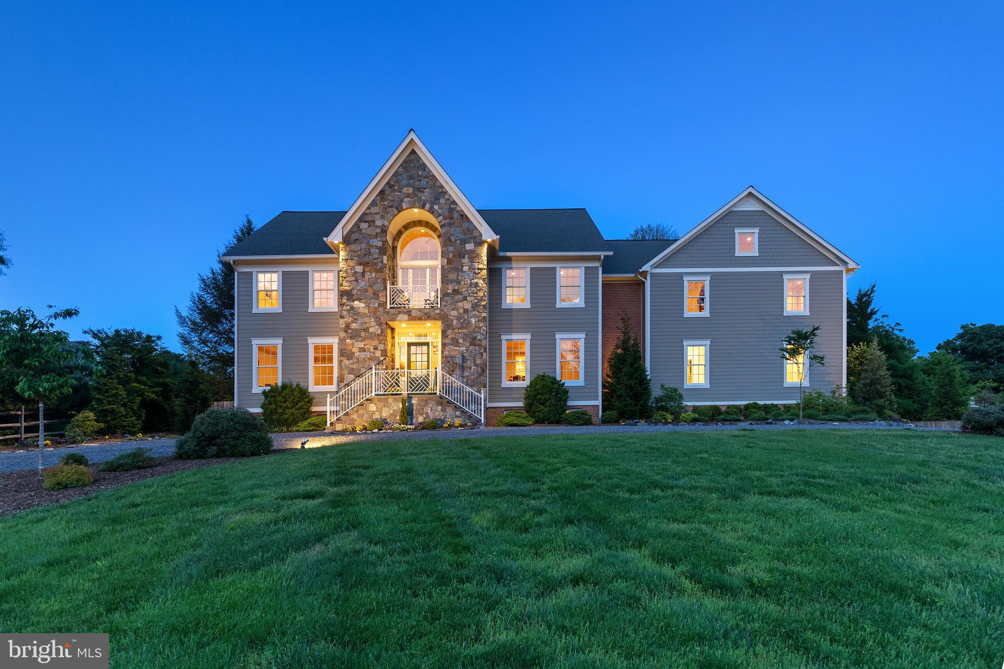 This stunning custom-built estate sits on 1.25 acres of land and boasts exceptional quality. With its Marvin windows and front door, complemented by a slate patio and a custom cherry wood entrance door, you know that the home was treated with love and attention to detail. The covered patio has ceiling fans to keep you cool and provides you with a place to sit outside and read a book while being protected from the hot sun, creating a perfect blend of luxury and functionality.

The home features an inviting open design, highlighted by a modern kitchen beautifully flowing into the family room. A two-story family room connects to the living and dining areas on the main floor, complemented by a cozy library. Enjoy seamless indoor-outdoor living with easy access to the private backyard from multiple rooms. Additionally, the main level includes a versatile first-floor primary suite or in-law suite, equipped with handicap accessibility features such as a wheelchair-friendly shower and sinks, as well as a coffee bar, under counter refrigerator, and sink with an instant hot water faucet, perfect for making a cup of tea or hot cocoa without even leaving the room.  A mudroom and laundry room complete this level along with two full baths and one half bath.
Ascending to the upper level, a vast rec room with vaulted ceilings awaits, ideal for a family room, kids' play area, or teen hangout. Adjacent to the rec room is a guest bedroom suite with an attached bath. All bathrooms throughout the house boast generous dimensions and feature walk-in showers that don’t need doors. Two more sizable secondary bedrooms with similar bathrooms are located on this level. You will never be left wanting something more in this primary suite, showcasing four walk-in closets, a lavish primary bath with a separate tub and shower, a bidet, and a breakfast bar that includes a dishwasher.
The lower level is perfectly styled for entertainment, featuring a sprawling rec room area with tile floors, a stylish bar crafted from natural building stone, a cozy stone fireplace, a wine cellar, and discreet niches. A convenient bath is situated at the outside entrance to the lower level. The secluded rear yard offers an oasis for outdoor gatherings, complete with a built-in outdoor barbeque, fire pit, expansive covered porch, and access to the rear load three-car garage. Ample parking space is available for recreational activities, as well as a 30x30 basketball court.
The garage is nothing short of a car enthusiast’s dream. 
The garage boasts a range of features designed for convenience and functionality. With space for three cars and bays measuring 14 feet, double-stacking vehicles is easily achievable. Additionally, the garage is equipped with heating, wash bays, and a dedicated hose bib, ensuring optimal conditions for vehicle maintenance. Its sloped floor facilitates washing and working on cars without being hindered by the weather. Smart device-operated garage doors add modern convenience, while two EV charger outlets cater to electric vehicle owners. Moreover, wheelchair rough ins enable easy access from the garage to the main level, enhancing accessibility throughout the property. The impressive garage also provides access to a spacious four-foot-tall, conditioned crawlspace for additional storage.
All of this is nestled in a vibrant equestrian community where humans and horses find harmony amidst picturesque landscapes and rolling hills. 8 miles of trails wind through lush forests and open fields, perfect for leisurely strolls or fun horseback rides. You will also find within the 30-acre recreational property, residents can enjoy a serene 7-acre lake for canoeing, kayaking, swimming, fishing, and paddle boarding. As well as a horse riding ring that provides a safe space for training and leisurely rides, while the skating pond offers winter fun for all.