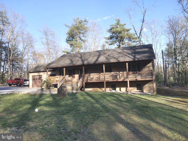 This property will check all the boxes.  The 4+ acre wooded lot offers great privacy, especially from the front covered porch and rear deck.  The lot is mostly level, has a long gravel driveway from  Quaker Woods Lane.  Quaker Woods Lane ends at a cul-de-sac and there are only a few homes along the Lane.  This home has an open floor plan, vaulted ceiling , attached 2 car garage.  The lower level is completely finished with a large familyroom (pellet stove), bedroom, full bath, utility room, laundry room, and what could be the 4th bedroom although no ingress/egress or windows.  The home has been very well maintained.  Pride of ownership will be obvious.  Offering easy access off Dillons Run Road.  10 minutes from Capon Bridge and  30 minutes  from the western edge of Winchester (Medical Center, Walmart).  No stoplights for the last 29 minutes!!  Come take a look.  You will be pleasantly surprised.
