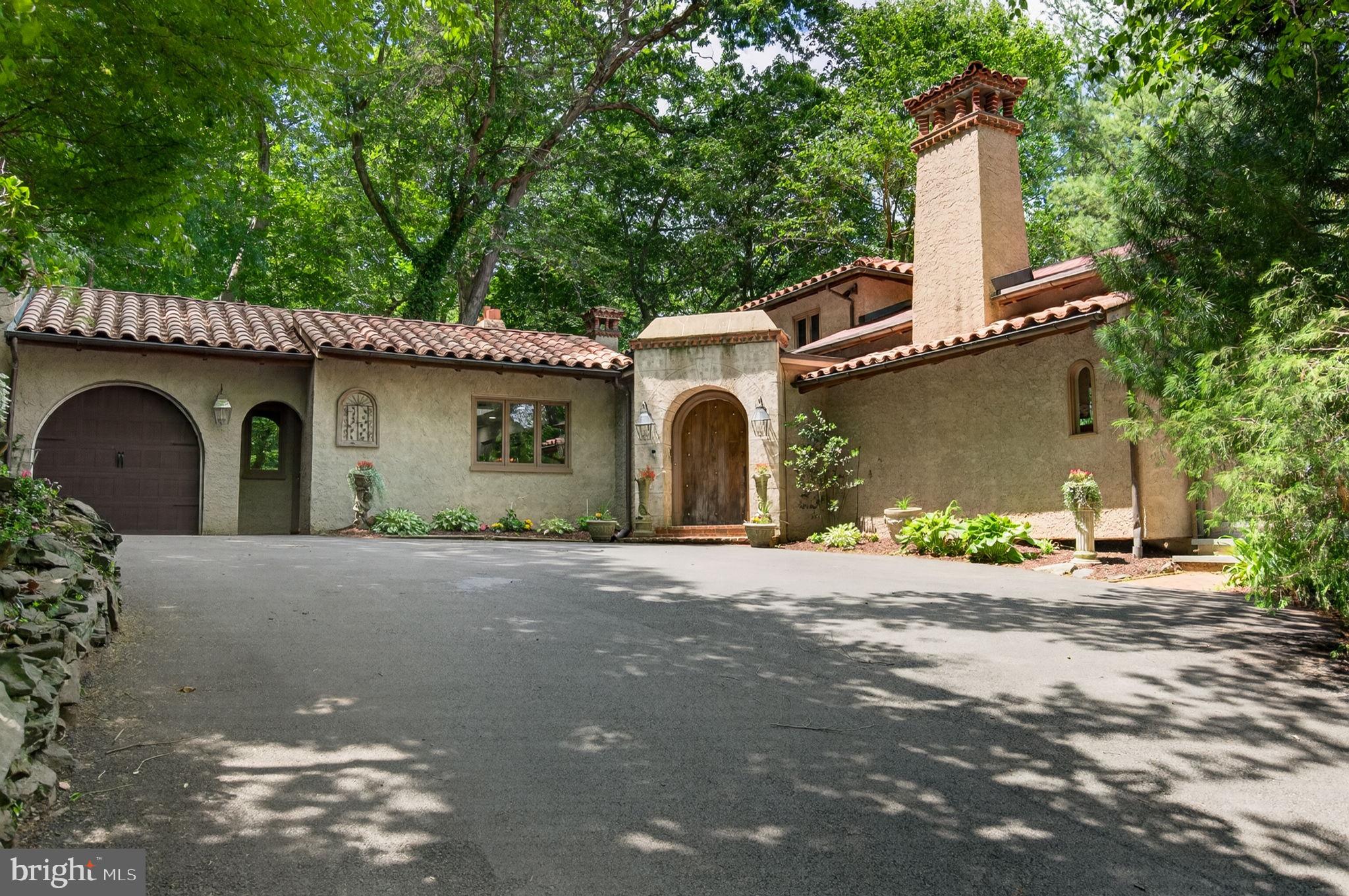 Nestled at 451 Mill Creek Road, this Gladwyne retreat offers the perfect balance of being a serene, private sanctuary that feels worlds away, yet sits just minutes from the Main Line’s best dining, high-end shopping, and easy commuter links. Tucked back on a lush lot, the home provides an immediate sense of calm and seclusion while keeping you firmly rooted in the heart of the prestigious Lower Merion School District.

As you enter the main foyer you will be immediately impressed with the generous sized rooms and natural lighting which streams in from all of the oversized windows and skylights found throughout this custom home. The expansive living room anchors the home with soaring ceilings, large gas fireplace and a welcoming built-in wet bar with ice-maker and custom cabintry. The entire room offers glorious views of the lush and vibrant setting from the multiple sliding doors (4!) which provide access to the spectacular wrap around terrace. The large, light-filled dining room is a wonderful compliment to the living room and is ready to impeccably host your large gatherings. With each room offering access to the stately terrace, elevated outdoor entertaining and enjoyment co-exist seamlessly throughout this level of the home. The sprawling eat-in-kitchen features two islands, granite countertops, an expansive custom side-by-side Electrolux refrigerator and freezer, custom double wall LG ovens, a new Wolf range and induction stove, a designated beverage/wine fridge, two sinks, two dishwashers and a charming breakfast room with access to the beautiful brick and slate patio. There is also a huge walk-in pantry, a second powder room which was recently updated and laundry room. There is a separate entrance to conveniently access this functional and well designed part of the home, making unloading groceries a breeze.  

The main floor is also host to the expansive first-floor primary bedroom suite offering first floor living at its finest. This coveted space has sweeping views of  and features a stunning gas fireplace, en-suite bathroom with separate wash closet, and anteroom with additional closets and open space that could easily be used as a home office, sitting room or nursery. This sprawling sanctuary offers true main-level convenience without sacrificing style, space or functionality.

Upstairs, there are two generously sized bedrooms with ample closet space and a large Jack and Jill bathroom. The original builders of the home had planned to expand the second floor to add additional bedrooms, but enjoyed the natural light from the multiple skylights, however please note the possibility for expansion if more bedrooms are needed.

The final show stopper of this home is the incredible walk-out lower level, which offers a powerhouse of options for the future homeowner.  Filled with natural light, this impressive space is currently configured as a professional-grade home gym and family room. The footprint is so generous (as it originally housed an indoor pool), that it could easily be reimagined as a private indoor pickleball court, a world-class wellness spa, a massive additional bedroom suite or screening room. With a private entrance, the options are truly endless!  There is plenty of additional storage on this lower level as well as two changing rooms and a full bathroom with a new shower. Among the many updates are 3 new HVAC systems (3 zones), an expanded and replaced driveway, and a new garage door.

Outside, the serenity of the lush grounds, the soothing sounds of the waterfalls and colorful blooming flowers make this extremely private setting truly spectacular, yet you are minutes to the Ardmore Train station in Suburban Square, numerous Lower Merion schools and an easy commute to the City.  Whether you are looking for a quiet escape or a well located home that can adapt to your elevated lifestyle goals, 451 Mill Creek Road, in the heart of Gladwyne, is a gem awaiting its next chapter.