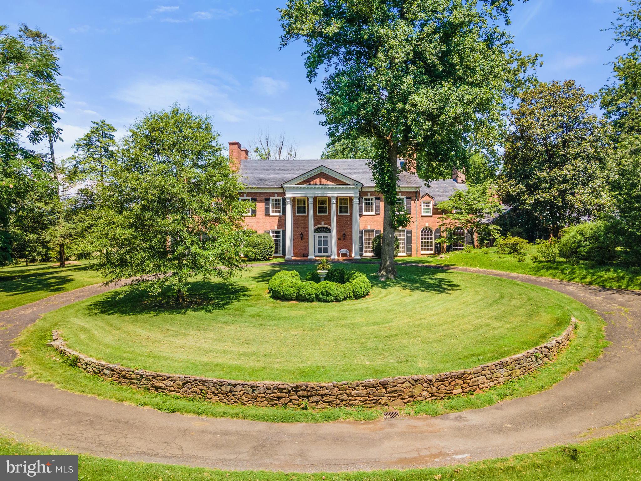 The Oaks, Circa 1932 is a stunning example of a Neoclassical-style mansion. The home is built of rubbed and glazed brick in an unusual English cross-band pattern on a stone foundation and has seven corbeled, double-end parapet brick chimneys and a slate gable roof. The front porch is a classic Revival-style portico with a herringbone brick floor and four extraordinary fluted Tower of Winds columns on limestone bases. The Federal-style front entrance is embellished with fluted pilasters, leaded glass sidelights and a leaded fan light.  Most windows and doors have limestone sills and keystones. A four-bay arcade connects the three car garage which has a 2-br apartment above and a large English-style greenhouse. 
       The rear elevation features a 60', two story, Greek Revival-style porch with a purple and green slate flagstone floor. French doors open on to the porch from the east Dining room and west Library wings. Cool summer evenings on the porch provide beautiful views out over the grounds and 113-acres of rolling Virginia Hunt Country. 
        One enters the front into a 16x28 Grand Hall with a palatial stairway with mahogony bannisters that leads to a landing with an exceptional Palladian Window and then up to the second floor.  There is a powder room and a concealed elegant back staircase that leads to all four floors. From the Grand Hall, one turns left into the 20x32 library with rare red gum paneling, bookcases and doors, and a fireplace. From the Grand Hall to the right is the 19x20 drawing room with fireplace, then a cozy pine paneled den with fireplace before entering the 30x20 dining room with fireplace and coveted Zuber wallpaper. The kitchen complex is next with a 16x9 butler's pantry, 20x10 cooking area and 12x12 farm office. All with beautiful glass-front cabinetry and undercounter cabinets.  The first floor features random width, wide plank oak floors, second floor has white oak floors, and the third has Alabama pine floors.
      On the second floor one finds four spacious bedrooms each with fireplace and private bath. On the third level there are three charming bedrooms and one hall bath. All together there are twenty two rooms, six bathrooms, twenty four closets and ten fireplaces. 
      The wonderful grounds offer an 18th century feel with vast green lawns, a lily pond with cast stone fountain, a log cabin purportedly salvaged from the previous house that was burned by the Yankees.  meat house, pool with bath house with full kitchen, bath and changing room, many flowering shrubs, hollies, magnolia, dogwood and oaks and cedar trees. 
       There are two cottages, each with two bedrooms, a barn and high on a hill - a covered, open stone summer house for watching the Virginia Gold Cup races from 1929-1934. 
       This historic property is listed on the National Register of Historic Places and the Va Landmarks Commission and is protected by a Va Outdoor Foundation easement.  The Oaks is located on Springs Road in an area widely protected by conservation easements, one mile from the historic Fauquier Springs Country Club and the Scenic Rappahannock River.    The newly consolidated 113.63 acre parcel has a tax number of 6973-03-0574.  Please verify current taxes.