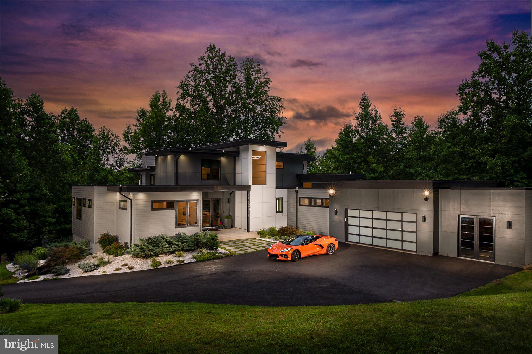 Presenting an architecturally stunning masterpiece situated on a secluded 2-acre estate lot. This elegant and distinctive residence offers the ultimate embodiment of modern design and lifestyle. Upon arrival, you'll be greeted by a striking exterior that features a 30-year TPO roof, tasteful hardiplank siding and paneling, sleek black Pella Architectural Series casement windows, and a welcoming 9-foot glass entry door that seamlessly blends with the lush greenery and carefully crafted hardscape.  From the instant you step inside, this custom-built luxury home captures your attention and takes your breath away. The interplay of clean lines and timeless color schemes creates a powerful and lasting impression. The first floor is adorned with a striking wall of windows, luxurious plank bamboo flooring, and solid 8-foot core interior doors.  The main level living room boasts a grand 20-foot ceiling, adorned with a captivating stone wall and a modern linear gas fireplace crowned by a floating mantel. For culinary enthusiasts, the true chef's kitchen is a source of delight, featuring custom cabinets, a generous 9-foot island, pristine quartz counters, and a convenient walk-in pantry.  Large glass doors lead to an expansive deck with elegant steel cable railings, providing an ideal outdoor space for evening relaxation while overlooking the inviting saltwater pool and charming fountains—an area primed for endless entertainment.  Additional rooms on the first floor enjoy 10-foot ceilings, including the romantic and spacious primary suite, which features a fabulous walk-in closet. The sophisticated primary bath offers a spa-inspired oasis, inviting relaxation in the freestanding soaker tub or the oversized glass-enclosed shower with meticulously chosen tiled walls. Dual quartz vanities and beautiful tile flooring complete the luxurious atmosphere.  A full-scale home office on the main level caters to your busy lifestyle, offering a quiet workspace and much-needed convenience. A secondary suite with its own bath ensures privacy and convenience for guests, in-laws, or an au-pair.  Conveniently located off the garage, a mudroom with built-in cubbies and a spacious laundry room adds a practical touch. Every room, angle, and space has been thoughtfully designed to create the perfect balance of space, tranquility, and lavish comfort.  The second floor reveals two generously sized bedrooms, an ample loft perfect for movie nights, homework sessions, and cherished sleepovers, and a modern full bath adorned with sleek fixtures.  The walk-out lower level boasts 9-foot ceilings and abundant daylight, featuring luxurious plank flooring throughout. Enjoy handcrafted cocktails at the custom-built bar, illuminated by LED lighting, and adorned with quartz countertops and textured tiles—a space that invites celebration throughout the seasons.  An expansive open rec-room boasts a linear electric fireplace and custom built-ins, setting the stage for relaxation and entertainment. Completing the lower level are a full-sized bedroom, a well-appointed bath, and a game room—elevating leisure and enjoyment.  Behind private doors near the bar, discover a golf simulator and lounge—a perfect space for perfecting your swing or unwinding in style.   A private studio, accessible via the garage or exterior entrance, features 12-foot ceilings, an elegant wainscot feature wall, and waterproof vinyl flooring—a versatile haven suitable for a gym, recording studio, or additional office space.  At ground level, a welcoming patio invites relaxation with a firepit and ample lounge space, creating an outdoor haven for tranquility and camaraderie. The crystal-clear saltwater pool stands as a centerpiece of leisure, providing months of rejuvenation and enjoyment.This remarkable estate is poised to become the backdrop for your new traditions, a place where memories are created,relationships are cherished, and the art of gracious living flourishes.