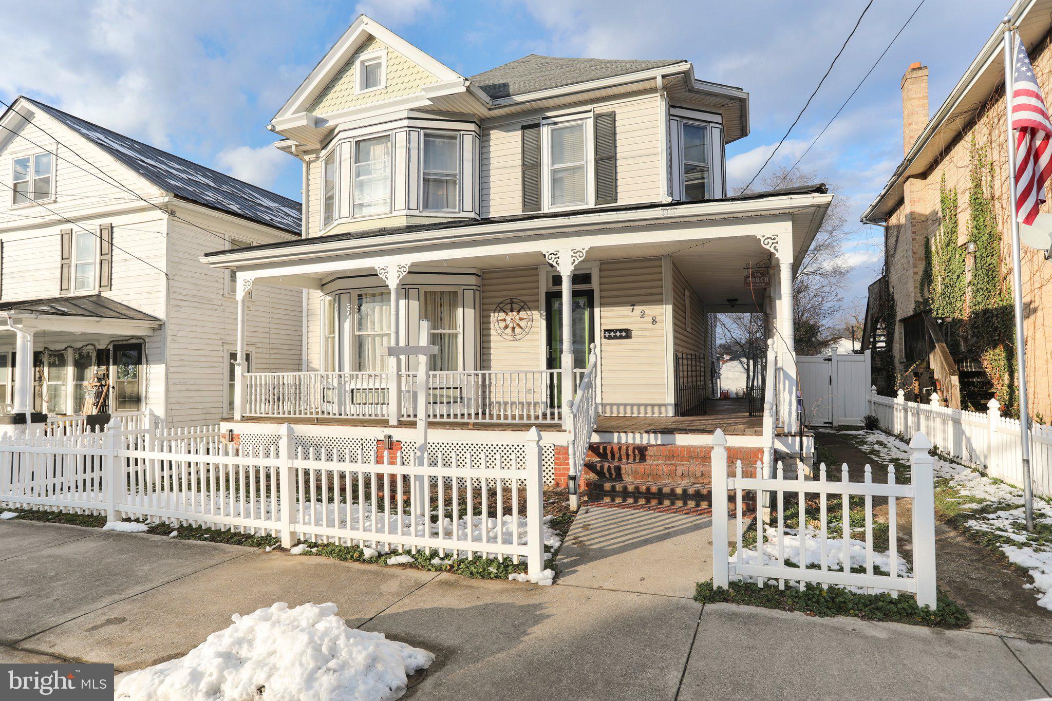 Beautifully updated 3 bedroom, 1.5 bath Victorian-style home within the City of Martinsburg! Hardwood flooring throughout. Main level offers a living room, separate dining room, eat-in kitchen with Corian countertops and sink, additional dining area, and half bath with laundry. Spacious bedrooms and completely updated full bath on upper level. Bedroom 3 has walk-up steps into floored attic. Full partially finished basement. Fenced-in backyard. 1-car detached garage with space for additional parking. Enjoy your days on the wraparound covered porch. Convenient location close to dining, shops, parks, Amtrak station, and commuter routes. Schedule your tour today!