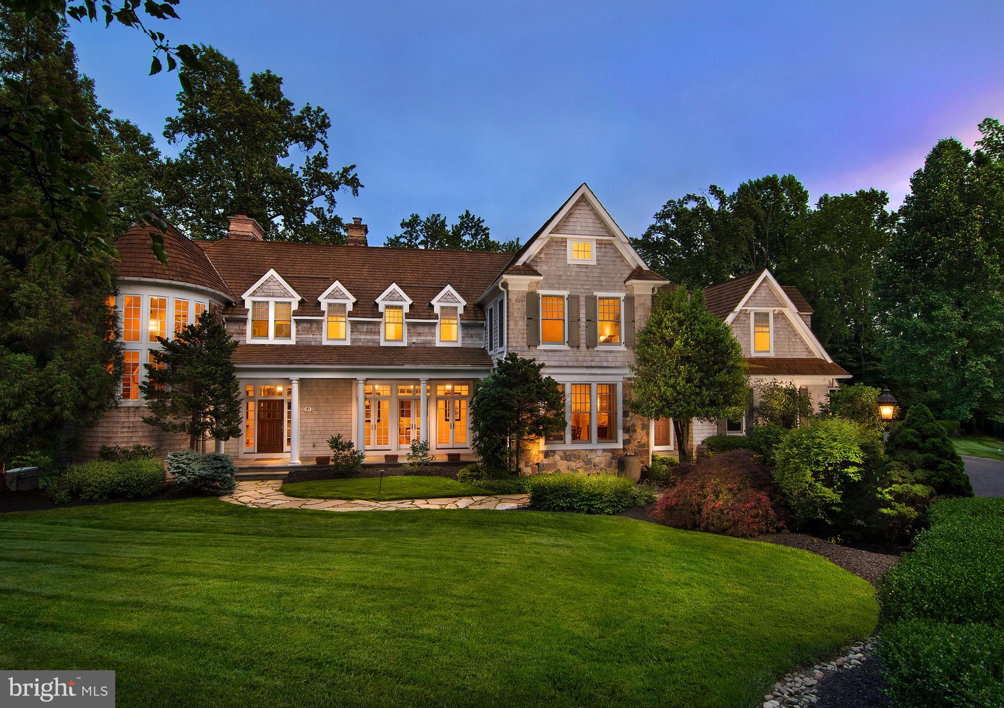 Discover the epitome of luxury living in this stunning, fully custom 5-6 bedroom, 7/2 bath stone and cedar home nestled on over 2 acres of private bliss. This residence, designed by architect Ann Capron and built by Chip Vaughn, is Springhouse at its finest, situated on a premium lot with its own gated access. Enjoy total privacy amidst manicured perennial gardens and entertaining terraces on this two-plus acre property while also having the ability to be part of a neighborhood. Approach through manicured gardens to behold the magnificent walled pool and spa, offering a resort-quality experience year-round. Step into the elegant foyer featuring high ceilings and a dramatic wide turned stair. Entertain with ease in the spacious dining room, boasting a full wall of windows overlooking the front gardens, or unwind in the formal living room featuring beautiful moldings and a marble surround wood-burning fireplace. French doors lead to the enclosed screened in porch, offering unparalleled views of the tiered rear yard and saltwater pool. A stately office with gas fireplace and cherry paneling provides a private space to work.

The family room features a coffered ceiling and natural stone surround fireplace and floor to ceiling French doors that open to the rear wrap-around terrace for seamless outdoor entertaining. Right off the family room, the spectacular chef’s kitchen awaits with Wolf and Subzero appliances, custom cabinetry, large island and separate sink and prep station. The kitchen opens to a beautiful sun filled morning room perfect for your everyday dining. Another office and large mudroom with a walk-in pantry are right off of the climate controlled 4-car garage that is perfect for any car enthusiast. Rounding out the first floor is a butler’s pantry between the kitchen and dining room and two powder rooms. The primary suite awaits on the upper level, with a gas fireplace, elegant arched French doors that lead out to a private balcony. There are also beautiful his and her baths and two outfitted walk in-closets.

Completing the second floor are four additional well sized bedrooms each with an en-suite bath and a sizable laundry room. The walk-out lower level is perfect for entertaining and offers a second kitchen, wine cellar, full bath, bonus room which can be used as an additional bedroom or an exercise room and billiard/game room. This meticulously maintained property has been lovingly enhanced and exceeds all expectations.