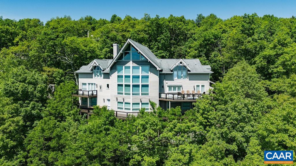 Welcome to one of the most impressive homes at Wintergreen, with expansive views of the mountain village, ski slopes and the beautiful Blue Ridge mountains.  Perfect for entertaining with a soaring great room, open floorplan and a well designed kitchen featuring double refrigerators and double dishwashers.  There are seven substantial bedrooms and all have attached full bathrooms.  The oversized den includes a modern wet bar.  Enjoy the expansive decking and soak in the stars while relaxing in the hot tub.  The current owners installed new flooring throughout, updated the kitchen, all 8 full baths and both half baths, painted and generally modernized this class chalet.  This is truly one of the premier properties at Wintergreen.,Granite Counter,Painted Cabinets,Fireplace in Bedroom,Fireplace in Den,Fireplace in Great Room