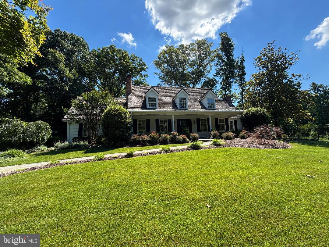 Beautiful, well‑maintained Cape Cod featuring an inviting covered front porch, cedar shake roof, Hardiplank siding, and a side‑loading garage, perfectly sited on a quiet court just minutes to Tysons and I‑495. The gorgeous almost one-acre private, treed lot offers slate walkways, beautiful  landscaped grounds, an irrigation system, whole‑house generator, and a storage shed.

Inside, enjoy a remodeled kitchen, updated tile bathrooms, and hardwood floors on two levels. Three wood‑burning fireplaces add warmth and charm throughout. The opulent primary suite includes his‑and‑hers walk‑in closets and a spacious private sitting room. Two additional bedrooms feature ensuite bathrooms.

Generous living and dining rooms complement the cozy family room that opens to the slate patio. The finished walk‑up lower level includes a recreation room, bonus room, fully equipped wet bar, and a large storage/utility room.

Located in the sought‑after Langley High School Pyramid. Optional membership available at nearby Woodside Lake.
