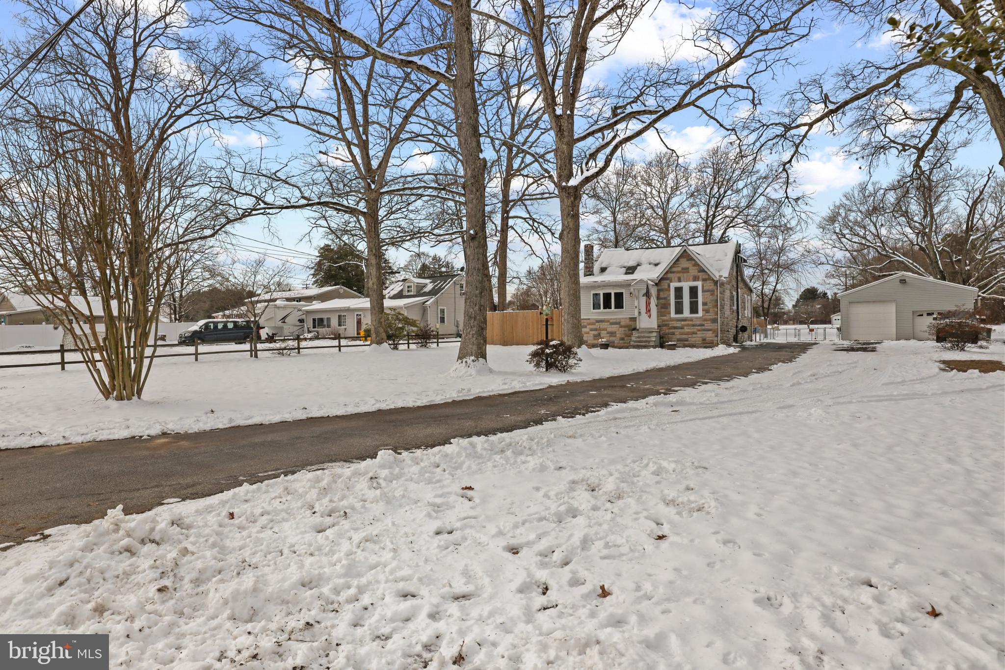 The perfect cozy renovated farmhouse with enormous detached garage and no HOA all on a level 3/4 acre lot SUPER convenient to Ft. Meade & BWI!!  You'll have plenty of room to enjoy the outdoors with extra deep front and back yards, fenced in area for play and direct access to the mechanics dream garage.  This generational home has been expertly renovated with modern conveniences like smart switches, recessed lighting, and energy saving double hung windows, public water & sewer!  Big modern kitchen offers wonderful natural light, beautiful and expansive granite counters, updated cabinetry with lots of storage and newer appliances.  The front foyer with coat closet can double as a picturesque work/study space.  Large living room with plenty of space for a dining table or play area.  Wonderful starter or downsize home for the one looking for more outdoors and endless possibilities in the oversized garage.   Schedule a tour today!