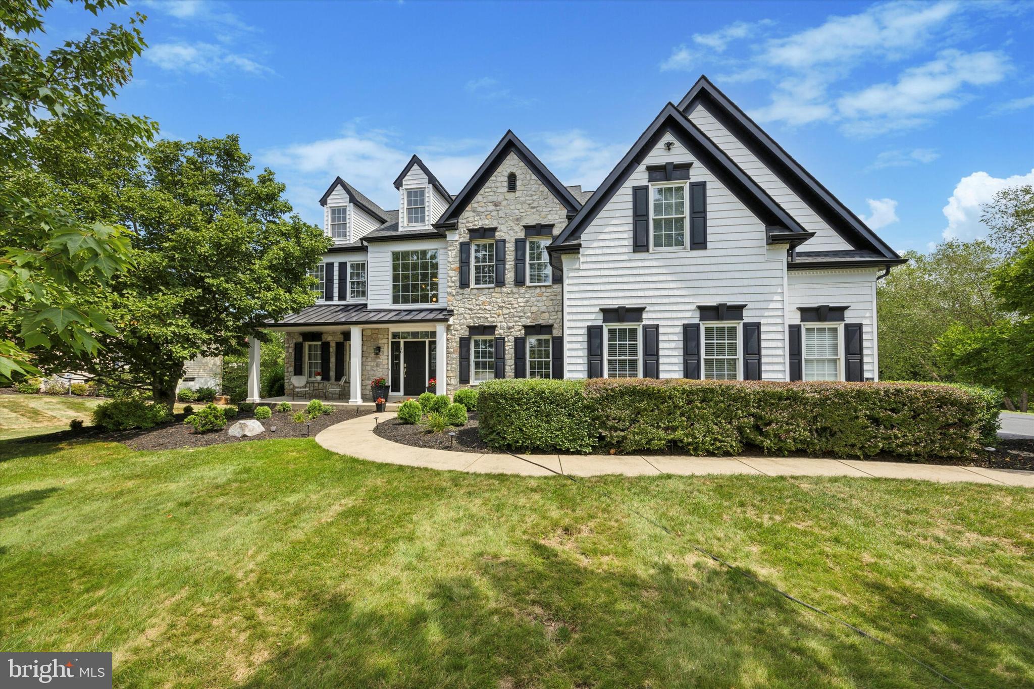 This is the one! Welcome home to 10 Longacre Dr in the ultra-desirable Estates at Faraway Farm community within the Spring Ford School District. This exquisite home, originally built as the model home, combines ultimate luxury and modern elegance, offering everything you could possibly ask for. The entire exterior of the home has been updated with gorgeous white shake siding, complemented by a new roof and gutters. As you walk to the front door, you’ll be greeted by a welcoming covered front porch, perfect for enjoying a morning beverage during the autumn transition. Upon entering the home, prepare to be dazzled by the vast foyer, complete with an elegant curved staircase and modern wood flooring throughout the first level. Immediately to the right, French doors open into an office area, while to the left, a sophisticated living room features 9+ ft ceilings and crown molding throughout. The path continues to a large, tasteful dining room with recessed lighting and a spacious bay window that allows gentle light to pour in, creating a special ambiance for meal times. The colonial center hall leads you into the grand kitchen, where upgraded quartz countertops, white cabinetry, and a large island with beautiful pendant lighting create a modern, open-concept space. The kitchen provides access to the laundry room, a walk-in pantry, a chic powder room, and a sliding back door to the new Trex deck, perfect for summer meals while enjoying the serene backyard. The expansive, sun-soaked family room boasts a two-story ceiling, a gas fireplace with a tasteful accent wall, and a second staircase. Completing the first floor is the two car garage which gives way to the home gym or extra storage space. On the second level, the primary bedroom offers a massive space with a tray ceiling, leading into a central sitting room and walk-in his and her closets. The primary bathroom features a soaking tub, double sink, and stand-up glass shower. Bedroom two offers ample space with its own attached bathroom, while the third bedroom shares a Jack and Jill bathroom with the hallway. The fourth bedroom is spacious and offers plenty of closet space. If the first and second levels are the main course, prepare yourself for an epic dessert as you head to the basement. This entire area is an entertainer's dream, featuring a full theater room, perfect for enjoying a spooky night this fall or a holiday film in the winter, a wet bar with granite countertops, an open TV area, and a separate room that could be used for cards or an additional office. Football season is upon us and it will get no better than enjoying a Sunday full of games in this basement. There is also a full bathroom on this level. The brand-new outdoor paradise, recently constructed, is an entertainer’s dream. It sits on expertly crafted stamped concrete and features a full bar with granite countertops, two built-in grills, and additional seating for guests. Built-in heat lamps ensure comfort on cooler nights, while the gas fireplace adds warmth and ambiance. With plenty of extra sitting space, this outdoor area is perfect for gatherings of all sizes. The fully fenced yard offers privacy and security, with passage to a new concrete staircase leading to the garage side of the home. Host with pride in this incredible backyard space, designed for both relaxation and entertainment. Additional perks of this home include three-zoned heating and cooling, two hot water heaters, all gas utilities, and two sump pumps. The location offers easy access to the Providence Town Center, downtown Phoenixville, Route 422, and all the wonderful amenities the area has to offer. Don’t miss this incredible opportunity to own a truly exceptional home in a prime location. Schedule your appointment today!