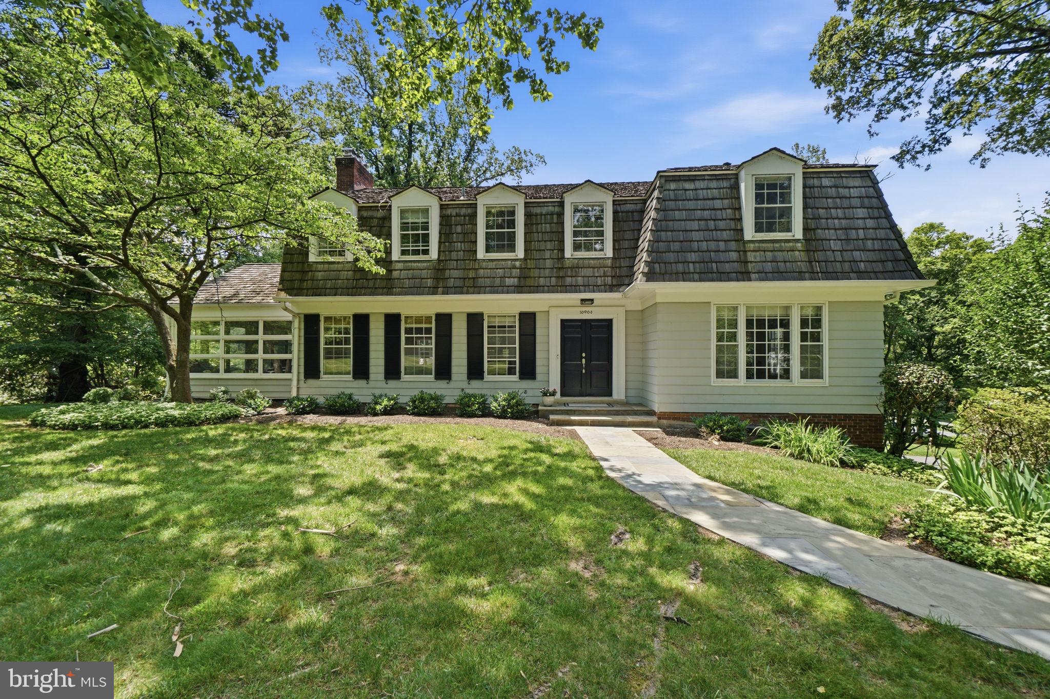 Nestled in one of Potomac's most sought-after neighborhoods, Great Falls Estates, and just a
pleasant stroll to the Village, this exceptional Miller-built residence offers timeless architecture, generous living spaces, and a spectacular outdoor setting. Constructed by Miller, one of the area's most respected and prominent builders, the home reflects enduring quality and thoughtful design throughout. Set on a stately, two-acre corner lot, the property is enveloped by mature trees that create a private, park-like setting. The outdoor amenities are truly remarkable, highlighted by an oversized swimming pool with diving board and pool terrace, extensive hardscaping, a 650-square-foot flagstone patio, and an expansive deck that spans the entire length of the home—creating an ideal environment for entertaining, recreation, and everyday enjoyment. A gracious central foyer welcomes guests and serves as the heart of the main level, flanked by an elegant living room and formal dining room. The generously proportioned living room
features a wood-burning fireplace and provides ample space for gatherings large and small.
The dining room comfortably accommodates 14 to 16 guests, making it perfectly suited for
holiday celebrations and memorable dinner parties. Throughout the main level, 9-foot
ceilings enhance the sense of openness and light. The kitchen is designed to accommodate both everyday living and large-scale entertaining, featuring abundant workspace, handsome wood cabinetry, granite countertops, and a substantial center island. Adjacent to the kitchen is a spacious breakfast area with a built-in banquette and dedicated desk space, creating a comfortable and functional gathering area
for casual dining, homework, or household management. Additional main-level highlights
include a private study, ideal for working from home, and a sunroom that overlooks the
beautiful grounds and pool area. Upstairs, the spacious owner's suite is complemented by three additional generously sized bedrooms and three full baths, providing comfortable accommodations and flexibility for
family and guests alike. The walk-out lower level offers exceptional versatility and functionality. A legal guest bedroom with a private exterior entrance and full bath creates an ideal au pair, in-law, or
guest suite. The expansive lower level also features a large great room anchored by a wood-
burning fireplace, creating a warm and inviting space for entertaining or relaxing. A
recreation area and an impressive temperature-controlled wine cellar with capacity for
approximately 1,200 bottles further distinguish this level, offering amenities rarely found in
today's market.  Completing the home is an oversized two-car garage plus a third bay dedicated to storage,
providing abundant space for vehicles, equipment, and hobbies. With its coveted Great Falls Estates location, magnificent two-acre setting, exceptional outdoor amenities, and expansive interior spaces, this distinguished residence presents a rare opportunity to enjoy classic Potomac living at its finest. From the   level grounds and mature landscaping to the generous room sizes and exceptional entertaining spaces,
this is a home designed to be enjoyed for generations.