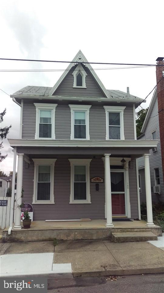 Borough of Carlisle! Freshly painted and move in ready! Featuring entry hall with crown molding leading to living room and formal dining room w/ corner gas fireplace. Remodeled kitchen - unique backsplash, flat top range and eat at counter. MBR has office/computer room. Security system w/lights.Newer windows. Upgrades in 2005 - C/A, Furnace, 200 Amp service. 2016 Tankless gas water heater. Rear yard has firepit patio and 2 Car garage with alley access.