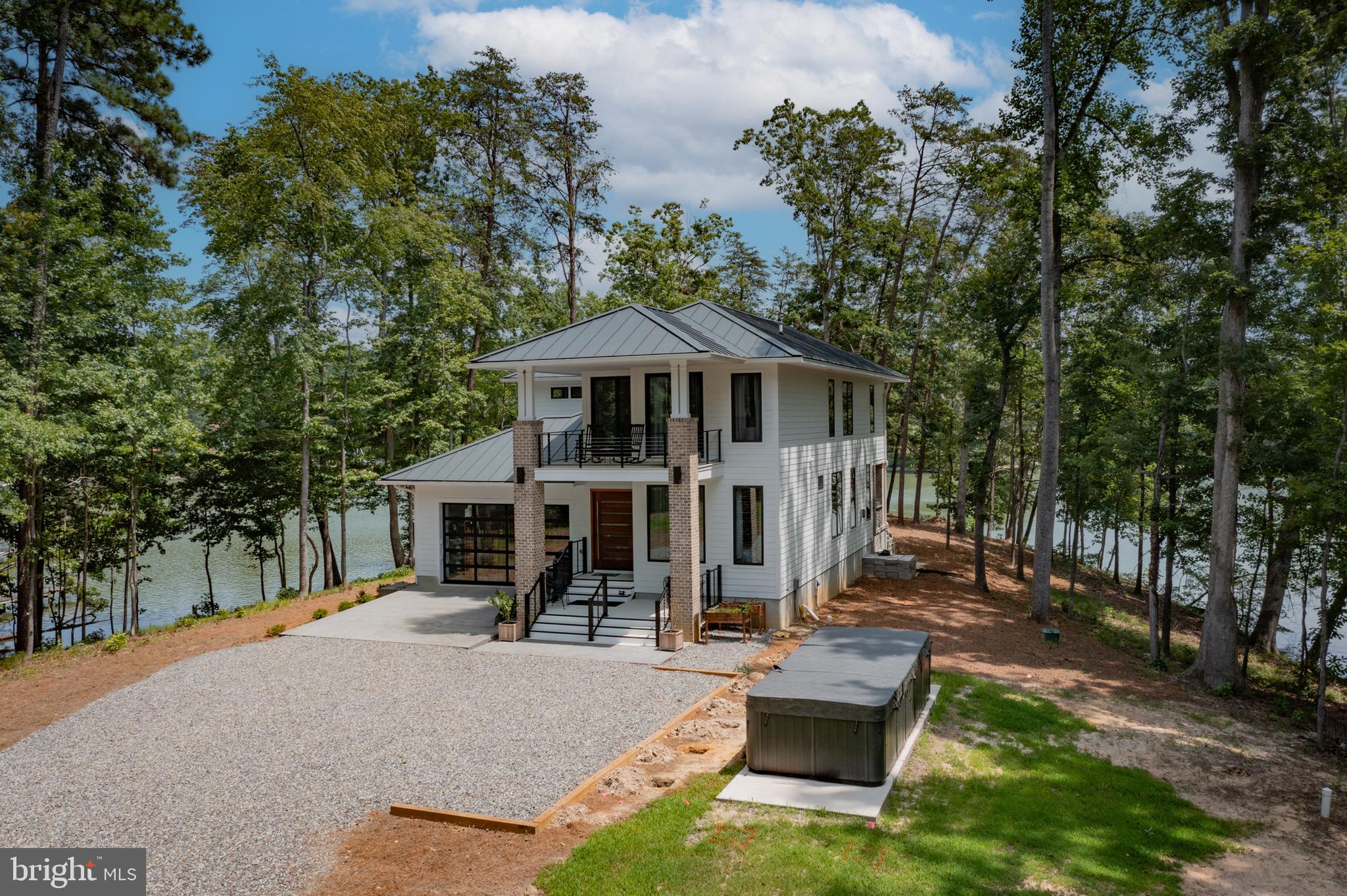 Designer touches accent this exceptional waterfront home newly built on Carter’s Creek. The two level modern style highlights the 180° water views and offers a comfortable but spacious floor plan. Custom built from top to bottom, inside and out, this home features top of the line appliances and fixtures, solid hardwood floors, Brazilian wood custom doors, extensive tile work, marble counters Weathershield doors and windows, 10’ + ceilings and multiple balconies, porches, and outdoor living spaces. Situated on 2+ acres with perfect elevation and wraparound views, this modern yet coastal home was carefully designed for its surroundings. New dock to 4' MLW (to be built). Located within sight of the Tides Inn and an easy boat ride to many waterfront restaurants and towns!