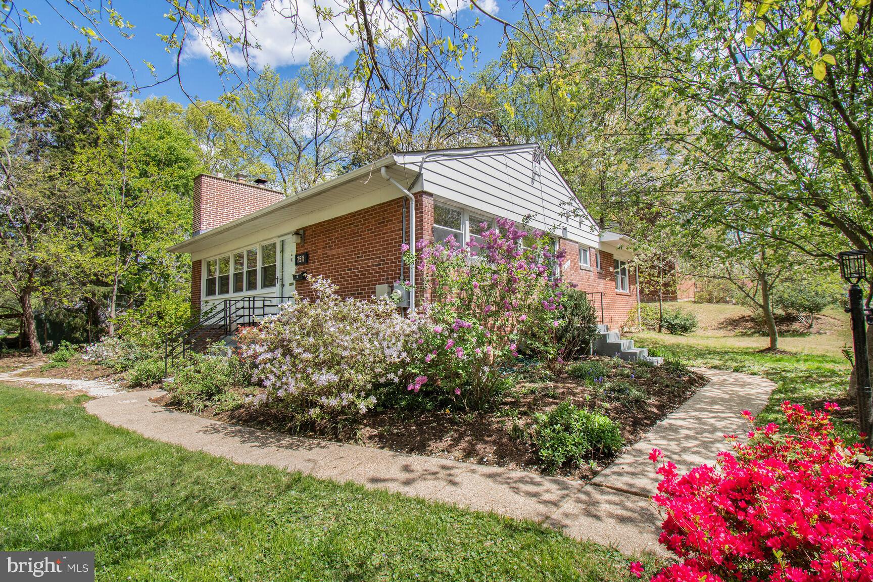 Adorable and updated Mid-century modern 1948 cottage on a corner lot and at a price you can afford in Takoma Park!  .03 mile to Takoma Langley Crossroads! Not your average rambler! This sweet house has been lovingly and stylishly updated and features original refinished hardwood floors, an open kitchen/ dining /living room, an owners bedroom with brand new ensuite bathroom,  and an updated hall bath. The living room features a wood burning fireplace with repointed chimneyand built-in shelves.  Off the living room is a wonderful large sunroom which leads to a lovely private patio, enclosed by beautiful brick retaining walls.  The kitchen features bamboo floors, granite counters, stylish white cabinets and a glass tile blacksplash.  The owners bedroom with barn door closet and bath sliders features a just renovated bathroom with gorgeous tile choices, new sink vanity and a frameless shower door. The other two spacious bedrooms are serviced by the hall bath, also recently refinished.   Lower level finished family room and laundry with recent ceramic tile  floor and lots of storage space. There is a detached garage and driveway for off-street parking for 2+vehicles.  Brand new roof (2025)! This is a great house which will appreciate in value over time as the Crossroads Metro completes construction.