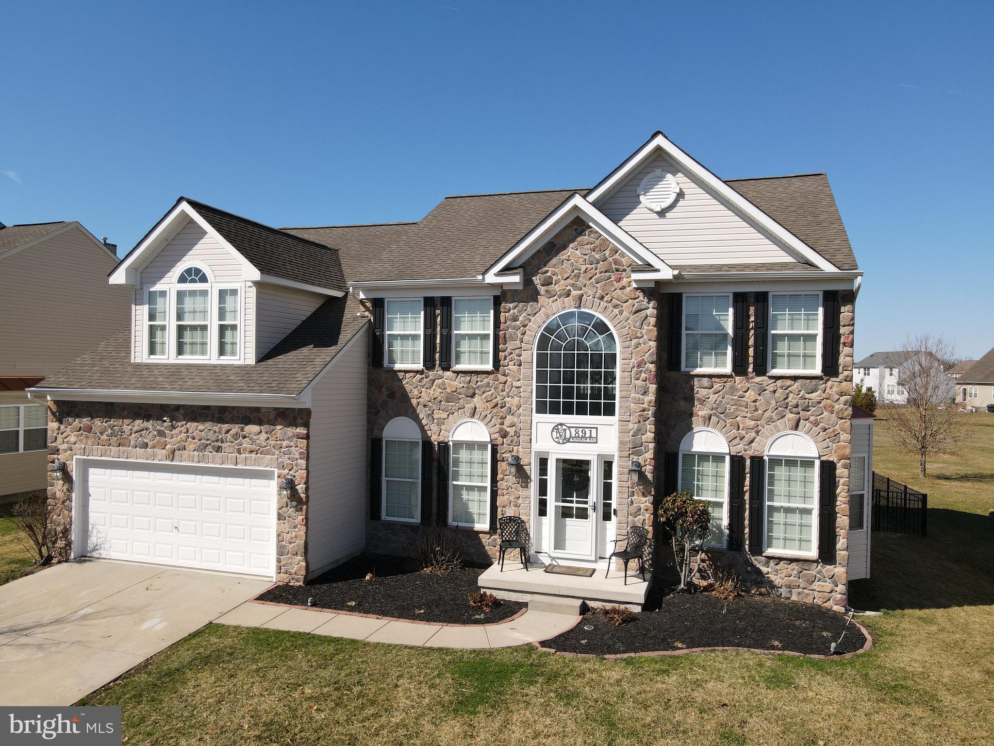 **This home has it all—Welcome to 891 Windrow Way in the desirable Chestnut Ridge Community!**

This 4 bed, 2.5 bath home is nestled in the highly sought-after Chestnut Ridge Neighborhood and served by the award-winning Caesar Rodney School District, this stunning stone-front residence offers luxury, space, and convenience in one exceptional package.

Step inside this over 4,900 sqft home  to a dramatic two-story foyer featuring an elegant "L" staircase, flanked by formal living and dining rooms perfect for entertaining or everyday living. The soaring two-story great room is the heart of the home, boasting a beautiful marble-surround gas fireplace and seamless flow into the open eat-in kitchen.

The chef-inspired kitchen shines with granite countertops, stainless steel appliances, a large center island, ample pantry storage, and a built-in desk area—ideal for meal prep, homework, or casual dining. Bathed in natural light, the adjacent sunroom opens to a custom stamped concrete patio, creating an effortless indoor-outdoor living experience.

Retreat to the luxurious primary suite upstairs, complete with a tray ceiling, cozy sitting area, and three generous walk-in closets. The spa-like ensuite bath features a tiled shower, corner soaking tub, and dual vanity for ultimate relaxation.

The fully finished basement is an entertainer's dream, offering a spacious recreation area, dedicated movie theater, and even a private recording studio. A rough-in for a future full bath and convenient walk-out entry add incredible flexibility and future value.
Why wait months (or longer) for new construction when you can move right into this turn-key, feature-packed home today? This is more than a house—it's a lifestyle upgrade in a peaceful, family-friendly community with top-rated schools. Schedule your private tour before it's gone!