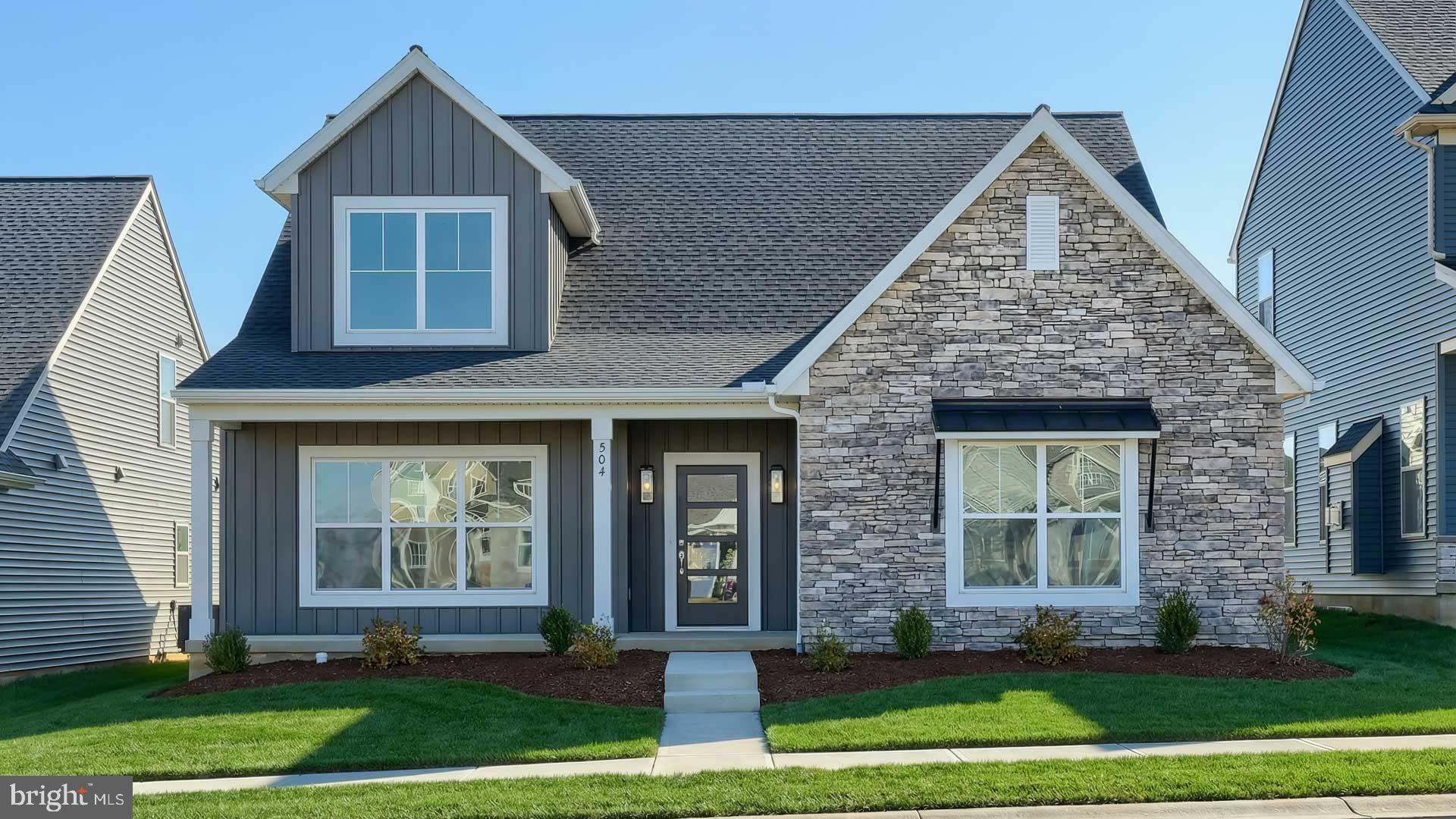 This charming 1-story home in our Winding Creek 55+ community includes a welcoming front porch, 9’ ceilings, and an unfinished bonus room on the 2nd level. The 2-car, rear-load garage opens to a mudroom complete with a built-in bench and large pantry. At the front of the home, there are 2 bedrooms and a full bathroom. Stylish vinyl plank flooring in the foyer extends throughout the main living areas. The living room boasts a cathedral ceiling and a cozy gas fireplace with floor to ceiling  stone. The kitchen features stainless steel appliances, attractive cabinetry and quartz countertops with a tile backsplash. The sunny dining area provides sliding glass door access to the rear patio. Tucked quietly to the back of the home, the owner’s suite includes a private bathroom with a double bowl vanity, tile shower, and an oversized closet.