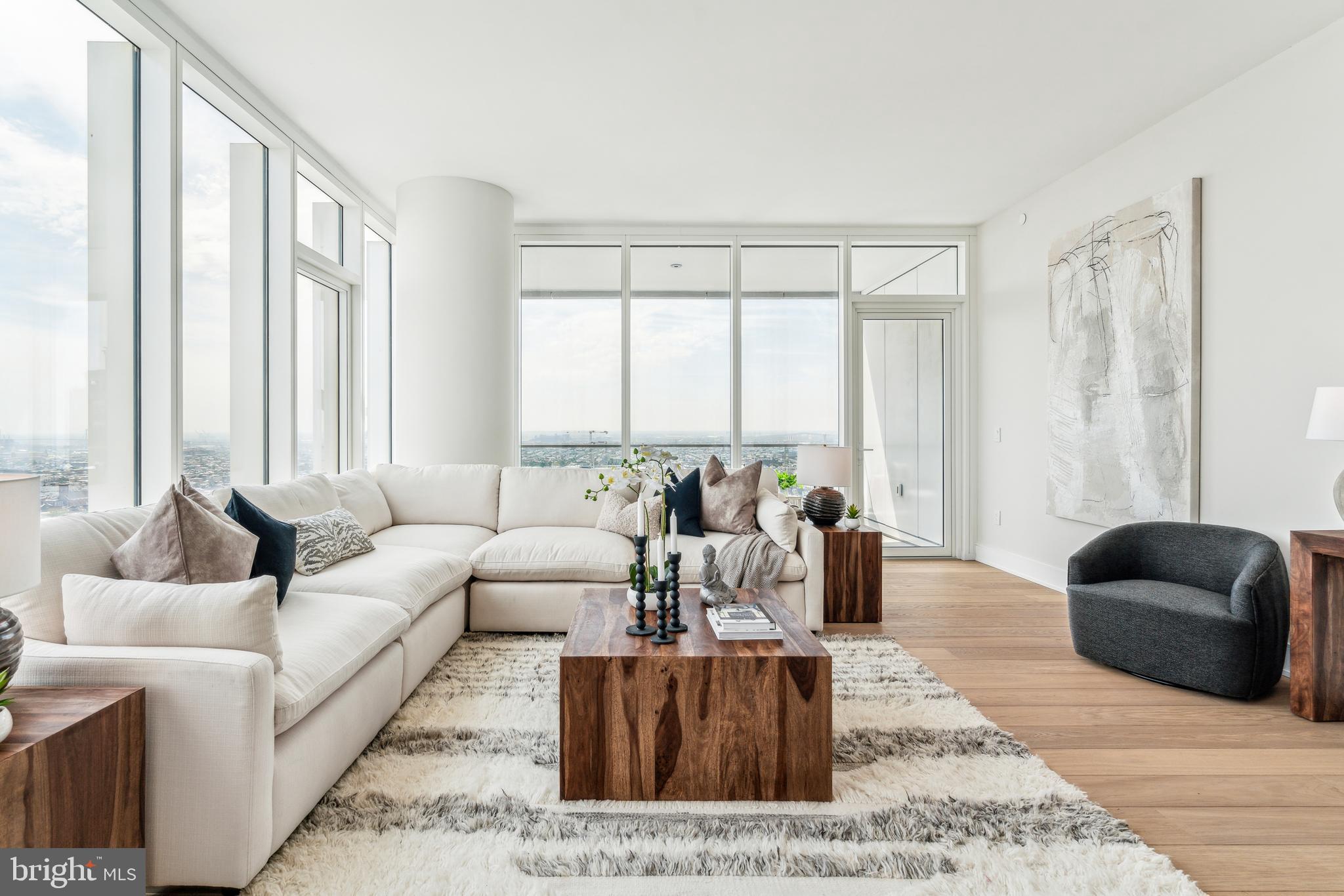 Arthaus, a commanding new residential high-rise in Philadelphia’s vibrant Performing Arts District, presents Residence 2202—a stunning 2-bedroom, 2.5-bath, 1,817-square-foot single-level home with sweeping midtown views, offered at $1,635,000.

This maintenance-free, move-in-ready residence features sophisticated interior design, resort-style amenities, and white-glove services. A tax abatement is available. Whether you’re a busy professional, discerning retiree, or global traveler, Residence 2202 is a must-see.

Arthaus impresses from the moment you enter. A tall, solid wood entry door with elegant hardware opens into a spacious, light-filled foyer with a generous coat closet, a convenient powder room, and a dedicated laundry room. The expansive Great Room blends kitchen, living, and dining areas into a seamless entertaining space, highlighted by soaring ceilings, floor-to-ceiling windows, wide-plank Havwoods hardwood flooring, and a weather-protected walk-out balcony. Bathed in natural light, the home feels bright, airy, and significantly larger than its square footage suggests.

The chef’s kitchen is designed for hosting, anchored by a large center island with seating for four. The Poggenpohl cabinetry in polar white pairs beautifully with Golden Gate quartz countertops and matching backsplash for a crisp, modern aesthetic. The premium stainless appliance suite includes Wolf, Sub-Zero, Bosch, and Asko, with fully integrated cabinet fronts for a seamless, bespoke finish.

The bedroom wing is located on the east side of the residence. The guest bedroom offers tranquil midtown views and a walk-in closet, making it ideal for guests or a home office. The adjacent full bath features porcelain Calacatta tile flooring, super white quartz countertops, and polar white matte Poggenpohl cabinetry.

The spacious Owner’s Suite is wrapped in 10-foot floor-to-ceiling windows and includes two step-in closets. The spa-inspired primary bath is appointed with a Badeloft soaking tub, double vanity with Robern mirrors, super white quartz marble countertops, Contempo white marble floors and shower tile, and a private Kohler water closet, delivering a best-in-class luxury experience.

Arthaus is a modern architectural masterpiece developed by Carl Dranoff, designed by Kohn Pedersen Fox, and built by Intech Construction. The building prioritizes wellness and lifestyle, from the Monet-inspired mosaic lobby to the private resort spanning the 6th and 7th floors, featuring a pool, fitness center, spa, salon, pet park, outdoor terraces, lawns, gardens, and more. White-glove services include a 24-hour doorman, concierge, chauffeured town car, and valet parking.

This residence includes one parking license. With the tax abatement, annual real estate taxes are approximately $3,443.