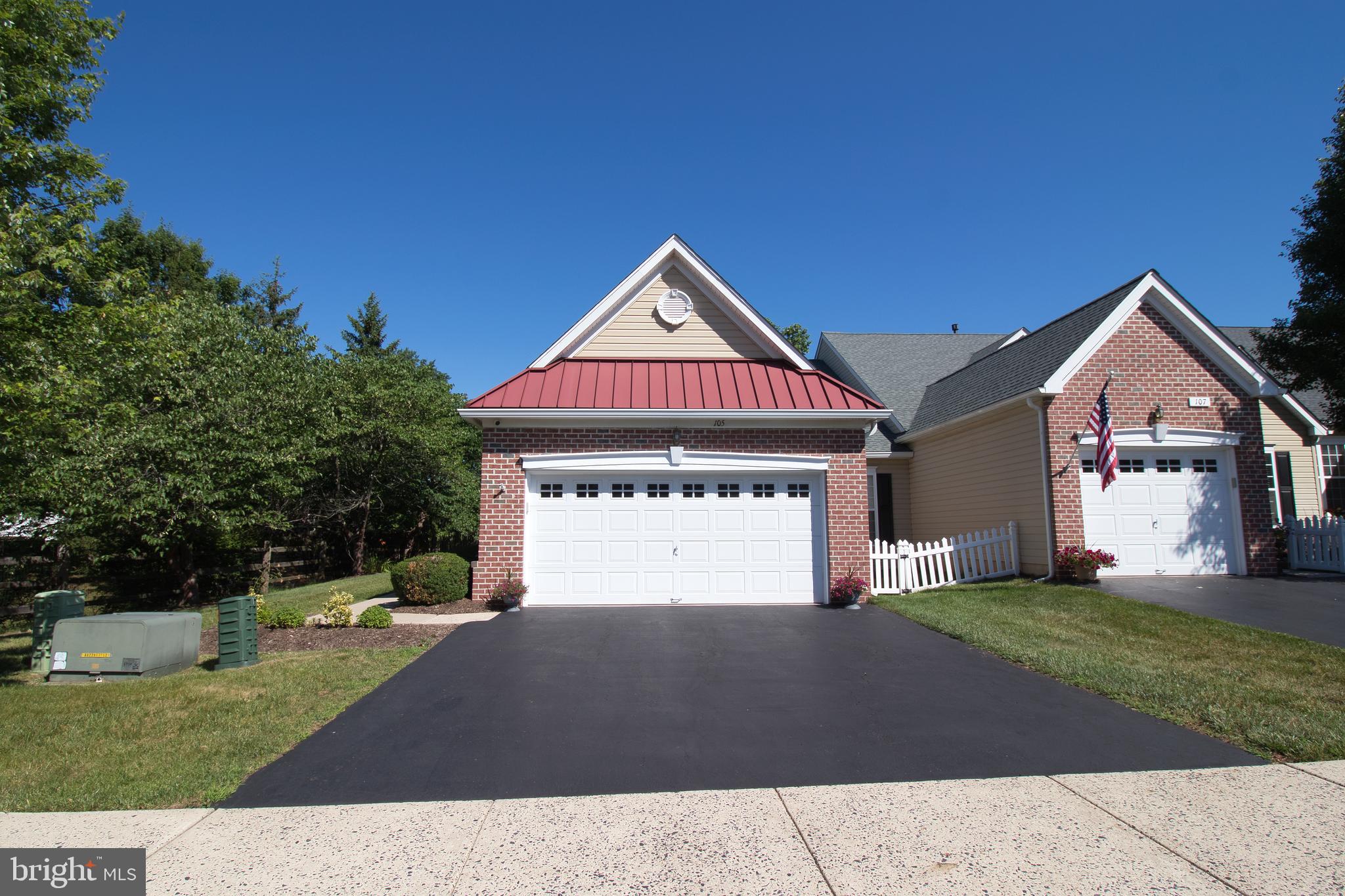 This is a beautifully very well maintained end unit home in the 55+ community of  the Village at Dorchester.  This end unit has the main entry next to a grass and wooded area adding to the privacy of this home.   The backyard has a beautiful paver patio to sit and relax. with an electric canopy.   As you enter the foyer with hardwood flooring,  you will notice how well this home has been cared for.   The main level of the home has an eat-in- kitchen with a double sink, granite countertops, plenty of counter space, dishwasher, built in microwave, and a gas stove.  
Off the kitchen is the laundry room and a walk in pantry.  The oversized 2 car garage is heated and has a beautiful work bench.  The bright and sunny dining room is great for entertaining.  The spacious living room also has plenty of sunlight, a gas fireplace and a vaulted ceiling.  The sun room is the best place to relax and have your morning coffee.  The primary bedroom has coffered ceiling, walk in closet and a full bathroom.  The second bedroom is next to the full hall bathroom.  The second floor loft which can be used as a third bedroom  which is now being used a sewing room also has a full bathroom, and a storage room.  Many improvements and up-grades to this home are available.