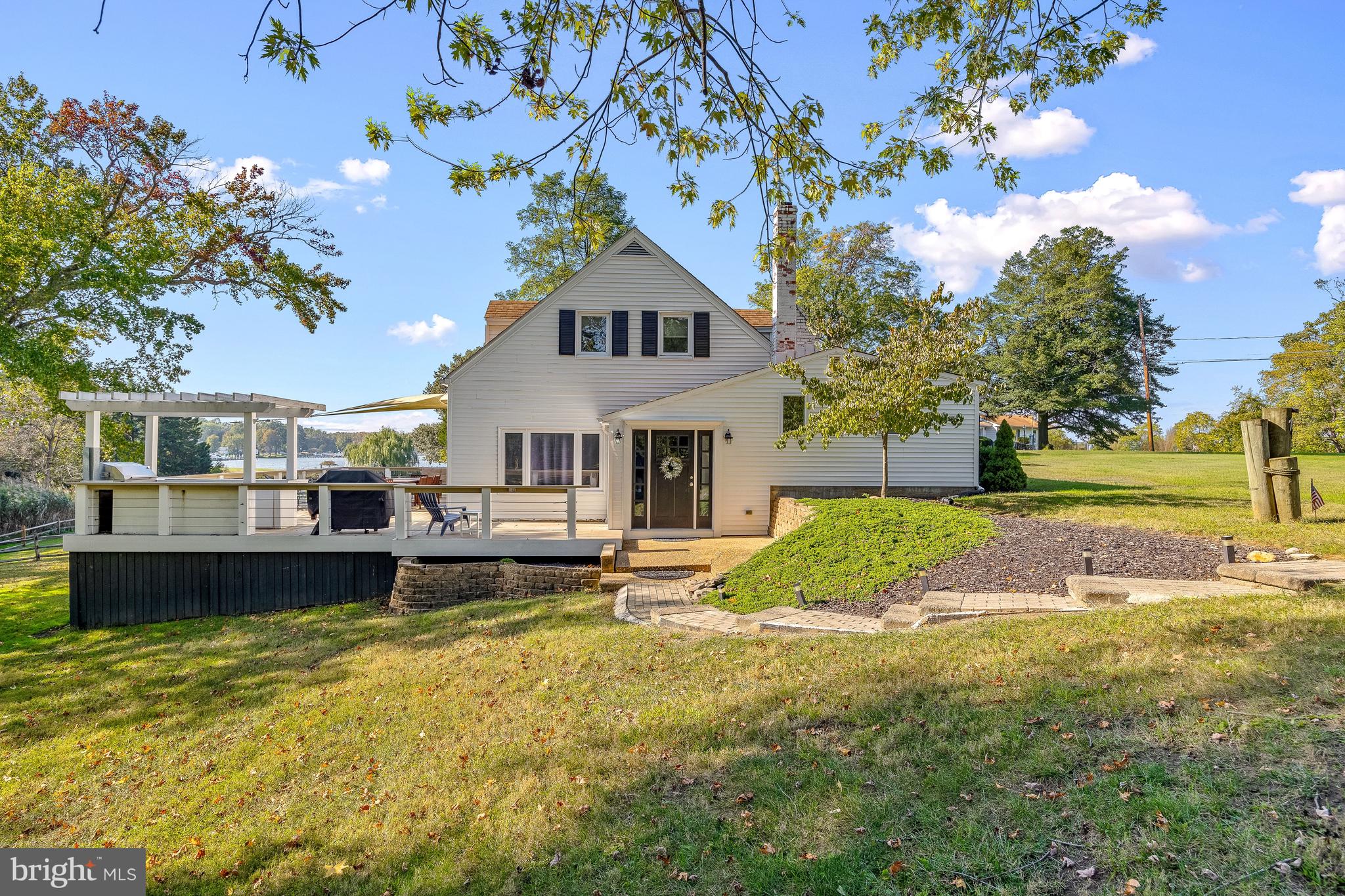 Set on almost 2 acres with a dock, this property offers a rare opportunity to enjoy the waterfront lifestyle for under $1M!!  A parcel of this size is exceptionally uncommon for waterfront properties in Edgewater, providing a sense of openness and room to enjoy the shoreline that is rarely found. With a private dock and water views, the setting invites boating, paddleboarding, and relaxed days along the water. A private fenced walkway leads to the dock, complete with a boat lift, jet ski lift, and convenient kayak storage along the shore, with quick access by boat to the Chesapeake Bay and downtown Annapolis.

The outdoor living experience is a true highlight, featuring an expansive deck with a pergola and outdoor kitchen, ideal for entertaining, crab feasts, or unwinding at sunset.

Inside, the 3-bedroom, 2-bath home is thoughtfully designed for comfort and functionality. The main level offers a seamless flow between the living room, dining area, and kitchen, along with a full bedroom and bath, mudroom, laundry, and additional storage. Upstairs, two spacious bedrooms share a full bath, creating a private retreat for family or guests.

Currently operating as a successful VRBO, the property also presents an excellent income opportunity, with its waterfront setting appealing to those seeking a Chesapeake Bay escape.

Located in Edgewater, with easy access to local marinas, waterfront dining, and downtown Annapolis—and within convenient reach of Washington, D.C.—this property is well-suited as a full-time residence, weekend retreat, or investment opportunity.