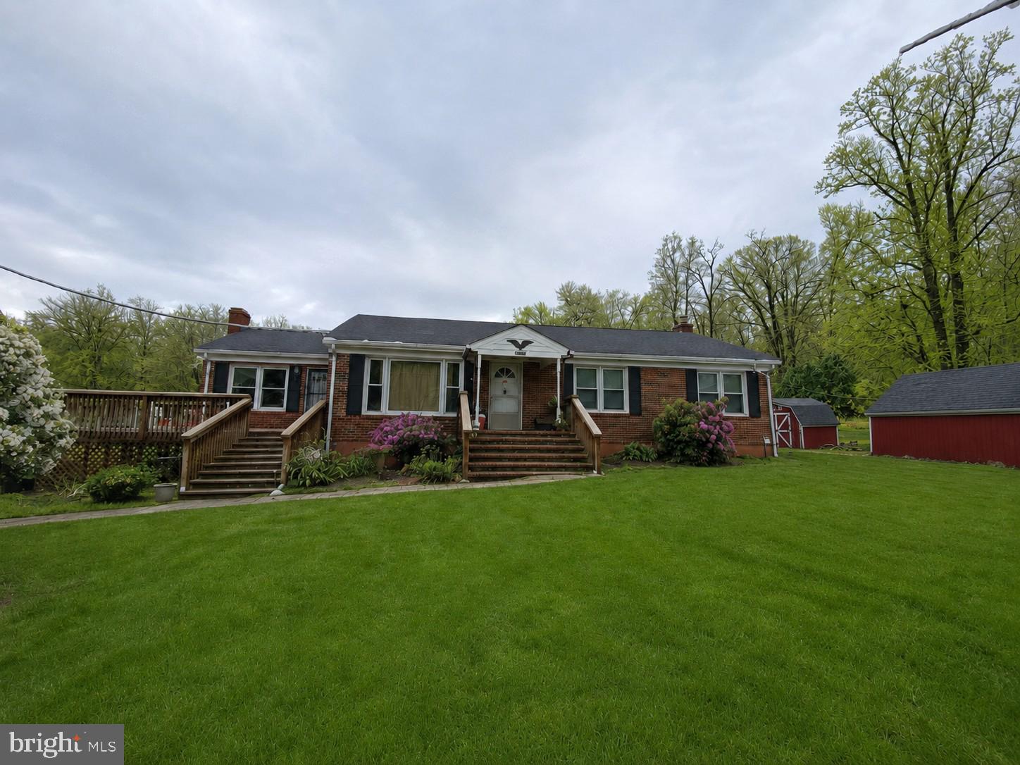 Presenting a solid all-brick home with flexible living space, major system updates, and room to spread out. The main level features 3 bedrooms and 2 full bathrooms, along with an additional flex room that could serve as guest space, office, or private suite, complete with its own full bathroom, separate entrance, and access to it's own deck. The home also includes a screened-in back porch, offering a comfortable space to enjoy the property and surrounding setting. The finished walk-up basement adds even more functionality with a kitchenette, full bathroom, it's own laundry area, and two additional rooms with egress windows that could be used as extended living areas. Set on a spacious lot with an established yard, mature surroundings, and multiple outdoor spaces, this property offers a practical layout with options for multi-generational living, guest accommodations, or added flexibility.

Notable improvements include a new roof in 2017, new windows in 2018, a new boiler in 2018 (not in use), new septic plumbing/upgrades in 2019, a new well pump and expansion tank in 2020, a new hot water heater and water filtration/softener system in 2020, a radon mitigation system installed in 2021, and a new HVAC system in 2023.
