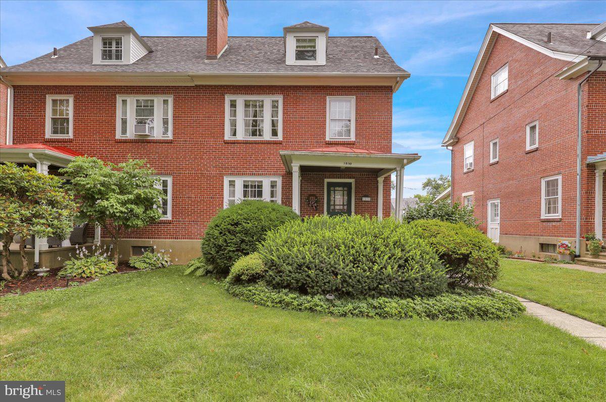 Character Meets Convenience in the Heart of Wyomissing     

Set on a quiet, tree-lined street right in the heart of Wyomissing, this well-maintained home puts you steps from the park system, community pool, high school, and hospital — without giving up the peace and quiet.  

In addition to its beautiful brick facade and covered front porch with wood ceiling, the exterior has been thoughtfully updated with a metal shingle roof (2014), vinyl-capped windows and soffits, and replacement siding, while stone landscaping walls and wood fencing frame the yard.  

Upon entry, a fireplace with insert and custom built-ins and gallery lighting is the focal point of the bright living room, while hardwood flooring flows under carpeting throughout nearly the entire main level. The dining room is elevated with character, thanks to two corner built-ins, chair rail molding, and a large bay window with built-in bench — ready for both everyday meals or special gatherings.  

The kitchen is set up for easy meal prep and casual bites with solid surface Corian counters, an electric built-in range, dishwasher, laminate flooring, ceiling fan, a small pantry, and a breakfast nook that leads directly to the back deck.  

Upstairs, three bedrooms each have their own unique touches. The first has a nice cedar closet, as well as carpeting and a ceiling fan, while the second features hardwood floors, a ceiling fan, and a full wall of built-in cabinets and shelving surrounding a double window. The third also has hardwood flooring and two tall windows for lots of natural light. All three share a full bath with a newer vanity and a tub/shower with a glass sliding door.  

An awesome walk-up third floor adds more living space, with angled ceilings and dormers, cedar accent wall, newer replacement windows, and two closets — ideal for a spacious home office, guest room, or bonus space.  

The partially finished lower level with a solid stone foundation offers so much potential, with multiple spaces, laundry, windows, and a powder room, which means plenty of storage and utility without feeling like a basement.  

Out back, enjoy an elevated view in the trees from the sizable deck with covered area, steps down to the yard alongside double stone walls, and a detached garage with additional off-street parking, automatic opener, and a newer door right off the alley.