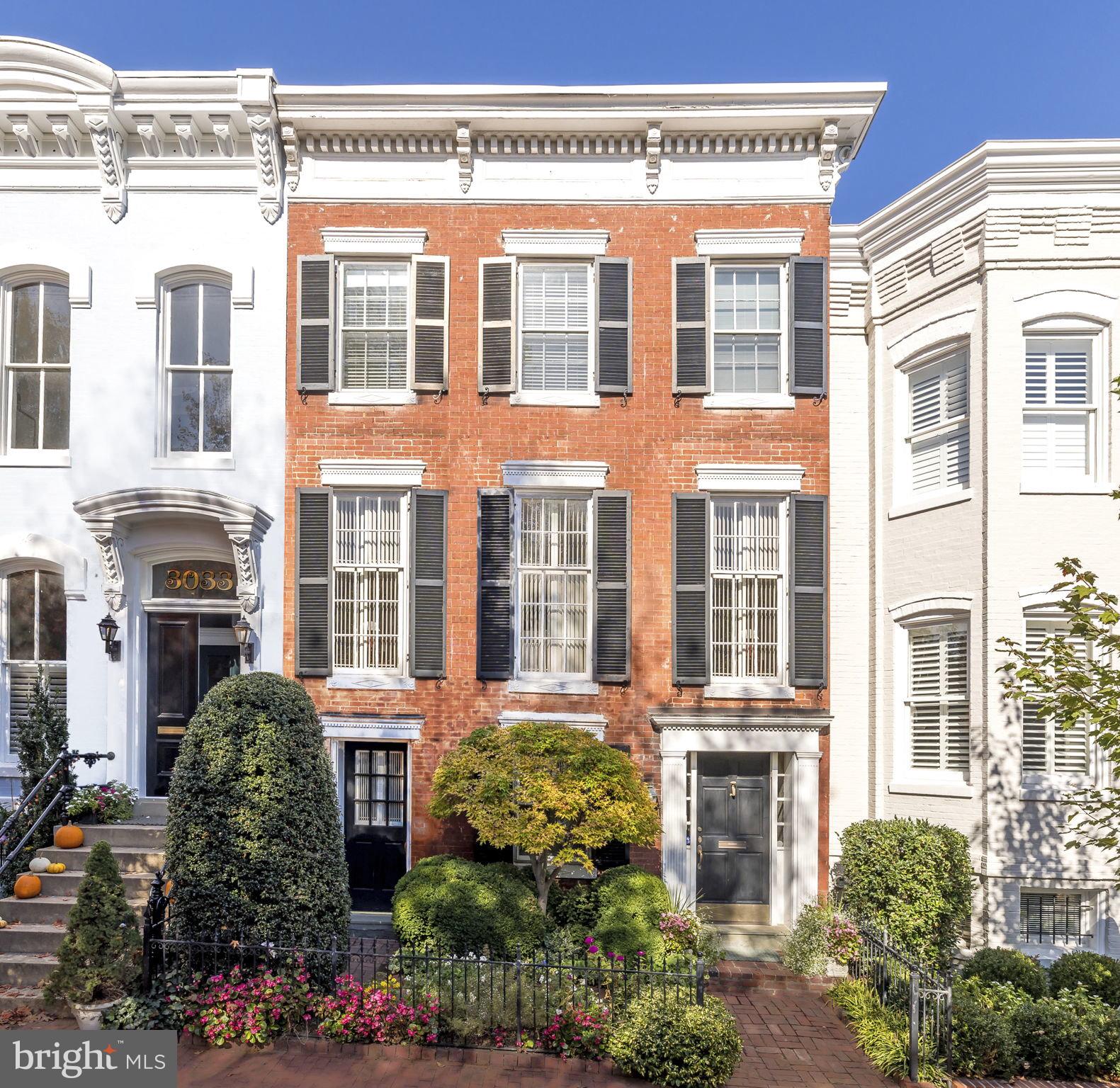 Incredibly special classic Georgetown Federal on one of the best blocks in the East Village. This gracious 3 Bedroom / 3.5 Bath home spans over 4,000 square feet and boasts modern updates along with original details. Recent updates include new roof installed by Wagner Roofing, new LG washer/dryer, new Lennox HVAC, new hot water heater and gas fireplace insert. Flexible floorplan features large, entry level bedroom with exterior access making it perfect as a separate guest/nanny/in-law suite or home office. Second floor boasts a stunning Living Room with gorgeous floor-to-ceiling historic windows affording all day southern sunlight, double fireplaces (both gas and wood burning) and custom cabinetry. Dining Room features spectacular cathedral ceiling with oversized skylight illuminating the entire living level. Kitchen opens to Family Room and includes new Quartzite countertops, new Subzero refrigerator, AGA range and Bosch dishwasher. Family Room opens to a charming deck overlooking a lush garden with mature annuals. Third floor features an oversized Primary Suite with 4 closets and a double marble Bathroom with an abundance of natural light from skylight above. An additional Bedroom and Den (both with fireplaces) plus sunny Hall Bathroom complete the top level. Rare opportunity to own a piece of history on a superb block!