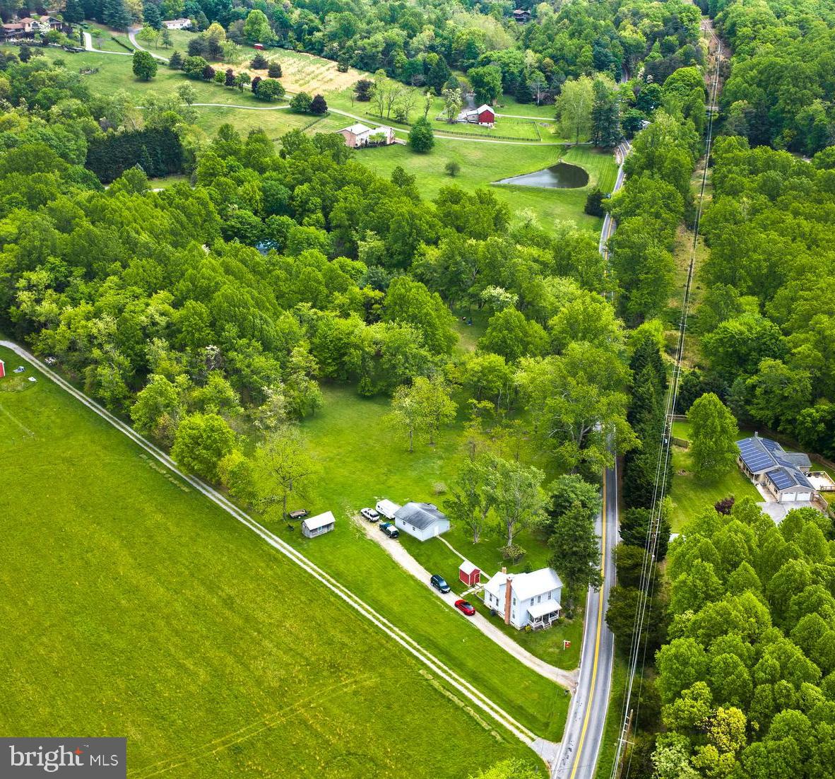 Coming Soon to Boonsboro, Maryland. Located outside the town limits. Just under 3.5 acres of open, flat land, partially wooded along the side and rear of the lot. This home was updated in 1995 and has been meticulously maintained. The home is tenant-occupied, and the tenant has taken exceptional care of the home. The owner has all systems professionally maintained with contracted vendors, including the HVAC and septic systems. Recently replaced the hot water heater and well pump. The HVAC is 10 years old and has a new oil tank. The home was completely updated inside in 1995, with new plumbing, electrical, and drywall. The bathroom was updated with a shower and tub, and a main-level laundry closet was added in the kitchen. Large country kitchen with laminate flooring, large and deep kitchen cabinets, and a Timberline wood-burning stove with stone masonry. Formal dining room and large living room. The upper level offers 3-4 bedrooms. One of the bedrooms is currently used as a closet, but it has a window behind the dresser. The carpet in each bedroom is older but in excellent condition. The basement has connecting stairs to the unfinished basement. There are also Bilco doors for access to the basement if needed. Step outside to a full-length front porch, a rear covered patio, and a gorgeous, flat, open yard. Two-car detached garage with power. Multiple outbuildings for storage as well. The views are stunning, with gorgeous pink and orange sunsets from your front porch. The property has a private well and septic. Property is being sold as is.