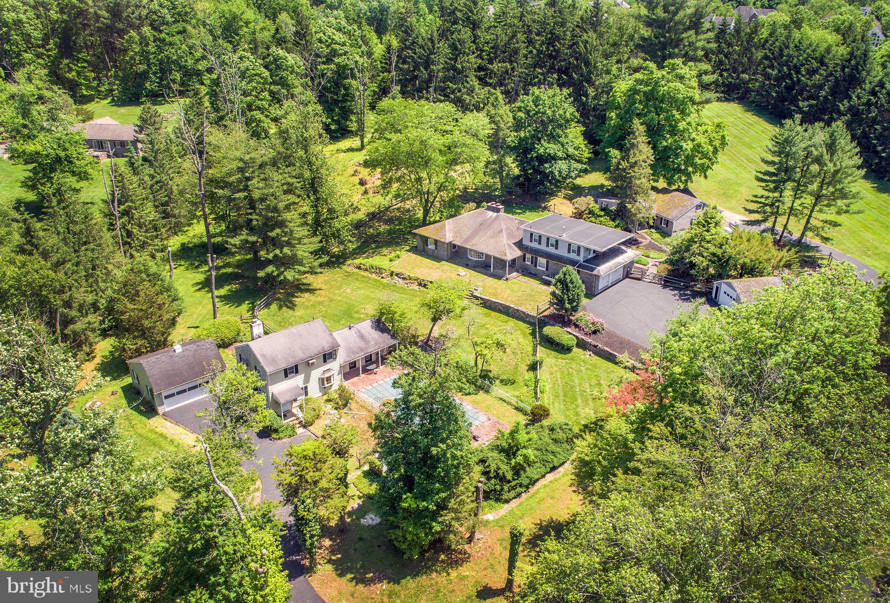 First time on the market and ready to be reimagined!  Fairfield is a unique family compound sited on almost 6 acres in 2 tax parcels on a quiet country road in Warwick Township.  The property includes the main house, a 2 bedroom cottage with garage and an additional separate garage.  There is also a large barn. All of the various buildings are well positioned throughout the grounds.
The house features a country kitchen that opens to a family room with doors opening out to a glass enclosed terrace.  The living room has a large bay window with window seat overlooking the pool and gardens, hardwood floors and fireplace.  There is a formal dining area and cozy hunt room with beamed ceiling and stone fireplace. The first floor also includes two bedrooms both with en-suite baths, a laundry room and half bath. The entire second floor is the primary suite with dressing room, cedar closet, full bath, fireplace with wood stove insert and a lovely, covered deck overlooking the grounds.  There is also a finished basement and a 2 car attached garage.
A 2 bedroom cottage with fireplace and garage is located down the drive thus providing privacy.  There is an additional detached garage as well as a large barn once used for horses.  The property has sprawling lawns with mature trees, gardens, various terraces and patios plus an inground pool.  

Located minutes to Doylestown in the Central Bucks School District, this unique property is just waiting for the next family to make it their own.