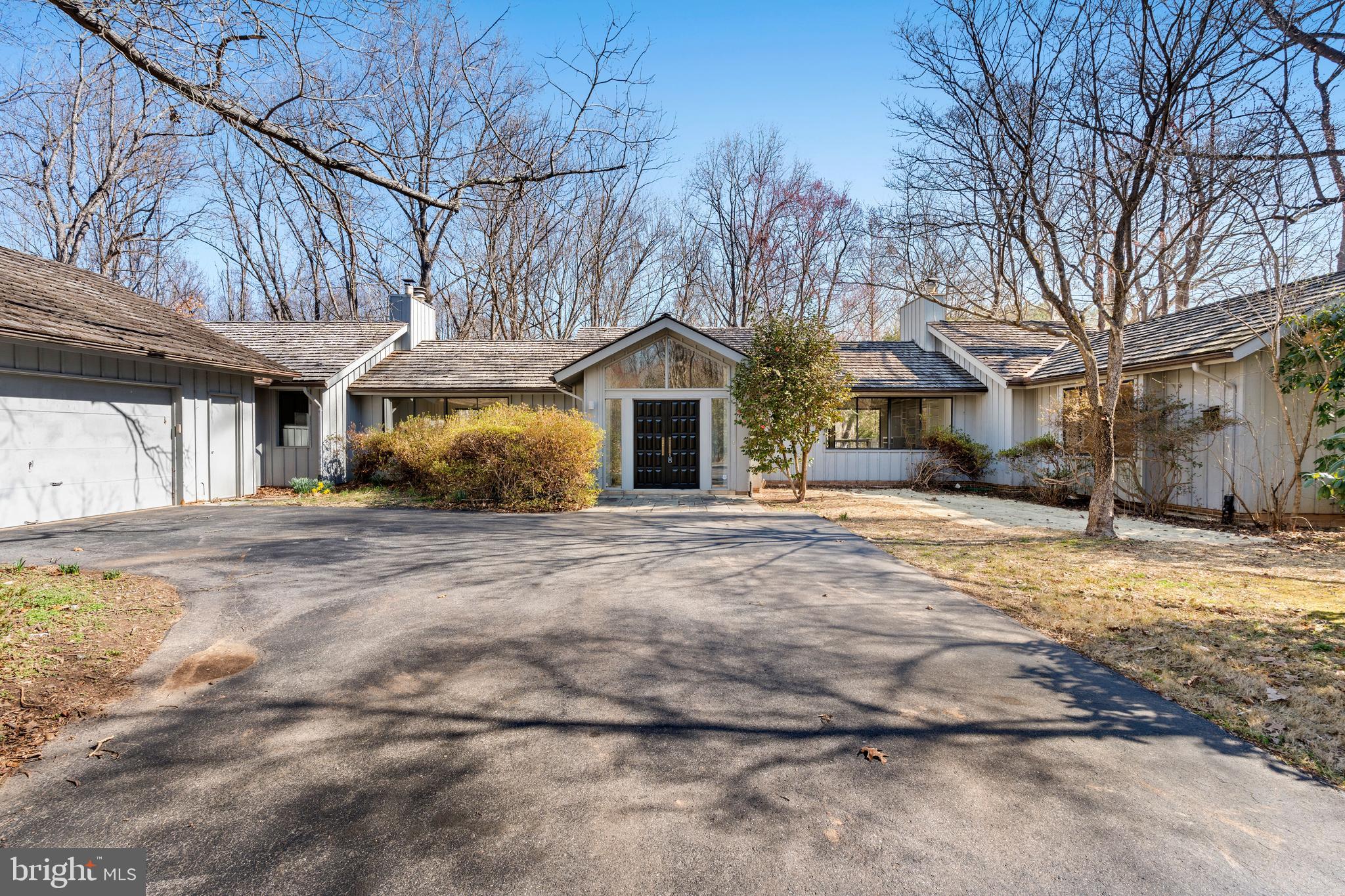 Welcome to this enchanting 5 bedroom, 4.5 bathroom mid-century modern house flooded with natural light and sitting on a 2+-acre, wooded, low-maintenance lot on a cul-de-sac just 2.7 miles west of Potomac Village.  With wood floors, large windows, cathedral ceilings and privacy, this is a large house that can accommodate a variety of living logistics and offers one-level living at its finest.  The rear deck spans much of the width of the house and is accessible from the living room, kitchen, dining room and family room.  The 2-car garage offers main level entry, and there is plenty of driveway parking for guests.  Candidate for further renovation.