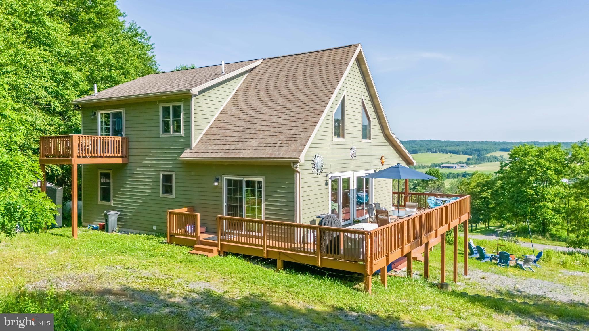 Beautiful 4 BR + loft mountain retreat minutes from Wisp Resort and Deep Creek Lake. Perfect as a vacation home or income producing rental. Spacious open floor plan, finished basement, large decks and wooded privacy. Sleeps 12+ with strong vacation rental potential. Get a Mountain Paradise: Spectacular Cabin with Breathtaking Views. This stunning cabin offers everything you need for the perfect vacation or weekend relaxation. With panoramic views of the surrounding peaks, you'll feel immersed in nature while enjoying the comfort of a spacious, beautifully designed home. Located in a serene and quiet area, this cabin offers the ideal environment for rest and rejuvenation, away from the hustle and bustle of city life. Just minutes from the ski resort, supermarket, and  lake, offering a combination of proximity and comfort. Large, open-air decks perfect for relaxation or entertaining, offering a seamless indoor-outdoor living experience. A state-of-the-art Swim Spa for ultimate relaxation, no matter the season. Whether you're cooling off in the summer or unwinding after a day on the slopes, this feature is a true luxury. Whether you're looking for an active vacation home or a  property to rent, this cabin is your option to year-round enjoyment. From ski trips in winter to lakeside strolls in the summer, you’ll have everything you need right at your doorstep. 3 levels of finished space. A spacious loft in the upper level, and a great recreation room in the lower level.  One gas fireplace that provides most of your heating needs. Spacious Kitchen with granite counters and  2 refrigerators. On top of all that you will find public water and sewer and High Speed Internet. The house will be sold fully furnished.