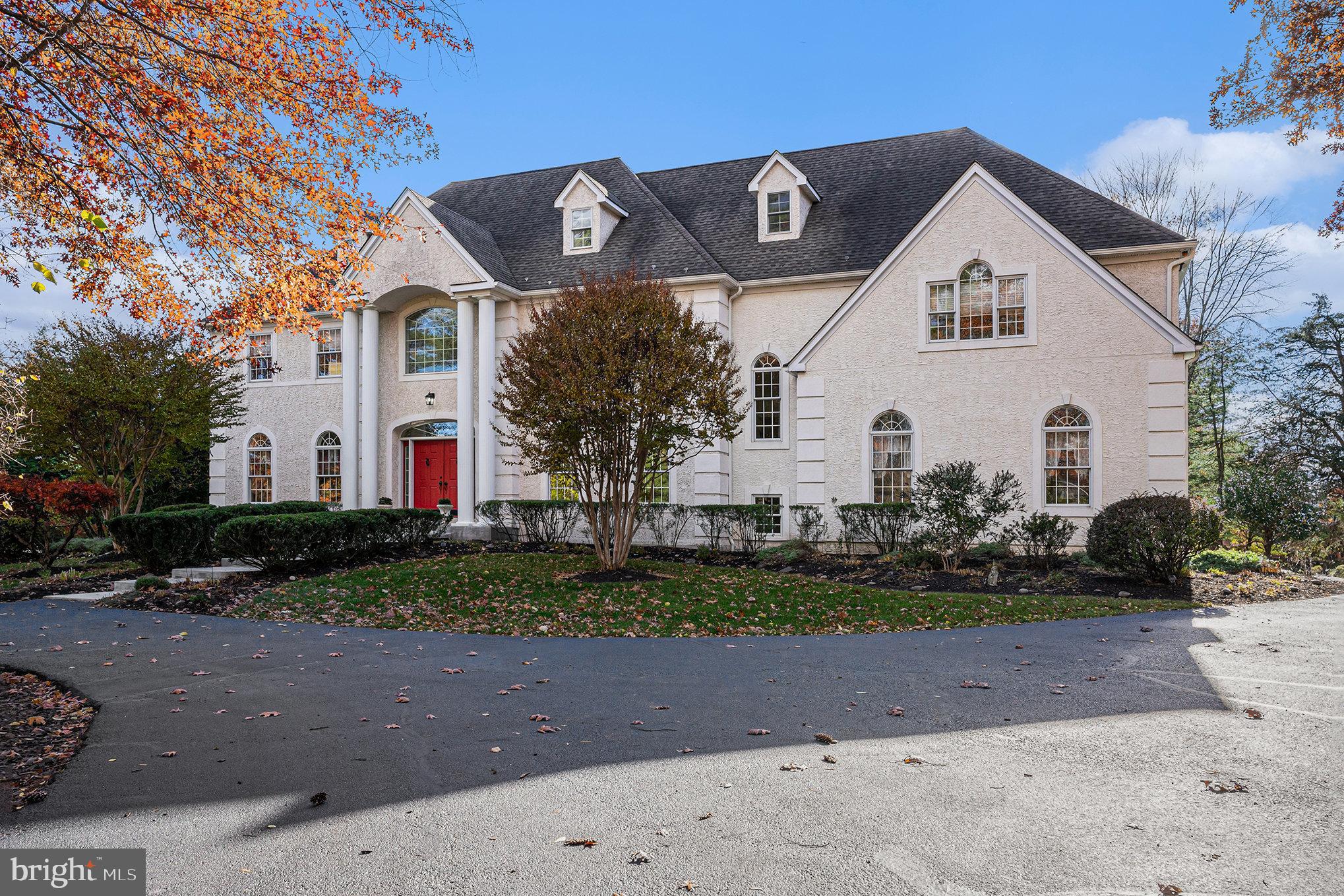 A legacy estate of enduring elegance and rare distinction, discreetly positioned along one of Lower Gwynedd Township’s most distinguished addresses. This exceptional custom estate is privately positioned on a lush 1.3-acre wooded lot, offering rare tranquility with everyday convenience. Thoughtfully designed and impeccably maintained, the residence blends timeless elegance with modern luxury across nearly 6,900 square feet of refined living space. From the moment you arrive via the grand circular driveway, the home makes a striking first impression. A dramatic two-story foyer with marble flooring and an elegant turned staircase sets the tone, flanked by a sunken formal living room and an elegant dining room, ideal for hosting memorable gatherings. The home's focal point is a two-story family room with cathedral ceilings and large windows that provide peaceful views and abundant natural light. Seamless indoor-outdoor flow leads to the backyard retreat—perfect for both entertaining and quiet relaxation. The gourmet kitchen is both stylish and functional, showcasing a neutral palette, high-end appliances, a generous center island, and a sunny breakfast area—ideal for casual mornings or intimate meals. Additional main-level highlights include a private home office with French doors, a light-filled sunroom, a spacious mudroom, and both a full and half bath, offering flexibility and everyday ease. Upstairs, the owner’s suite is a private sanctuary, featuring a sitting room and spa-inspired bath with serene views. The luxurious en-suite bath features a soaking tub, double vanity, and separate stall shower, all overlooking serene, tree-lined views. Four spacious bedroom suites, each with access to a full bathroom, offer comfort and privacy for family and guests. The third floor offers a private retreat with a sixth bedroom, and a spacious living area—ideal for guests, extended family, or a secluded lounge. A partially finished basement awaits your vision, offering the perfect canvas for curated leisure spaces like a home gym, wine cellar, custom entertainment space, or extended living. Outdoors, the expansive rear yard is designed for elevated living, featuring a resort-style outdoor living with double patio with pergola, surrounded by mature landscaping that creates a peaceful, resort-like atmosphere. The three-car garage, equipped with a dedicated charging station, adds modern convenience to this thoughtfully appointed home. This property is minutes from shopping, walking trails, and Gwynedd Valley Train Station, and sits within the Wissahickon School District, offering privacy and convenience. A rare opportunity to own a truly distinguished residence in Gwynedd Valley—where luxury living meets timeless design. Don't miss this rare opportunity to make this extraordinarily distinguished sanctuary of comfort, where comfort and convenience meet timeless design your own —call today to schedule your private showing and discover why this meticulously designed residence is the epitome of luxury living in Gwynedd Valley.