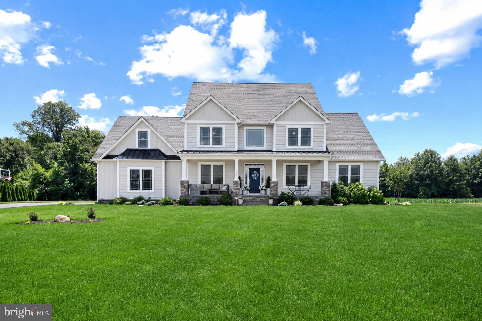 Discover the perfect blend of modern comfort and peaceful Eastern Shore living in this exceptional home nestled at the end of a cup-de-sac in the desirable Willow Branch East community. Built in 2022 and situated on a private 1.25 acre lot backing to mature trees, this exceptional home offers over 4,300 square feet of thoughtfully designed living space in a peaceful Centreville setting.
A welcoming front porch and entry foyer with elegant staircase set the tone as you step inside. The open-concept main living area features soaring two-story ceilings, creating a bright and inviting space centered around the beautifully appointed kitchen with quartz countertops, abundant cabinetry, and seamless flow into the spacious living room. The adjoining dining area overlooks the backyard and opens to the rear deck, making indoor and outdoor entertaining effortless.
The main-level primary suite provides the convenience of first-floor living and includes a spacious walk-in closet and private bath. Also on the main level are a dedicated home office, a formal living room that can easily serve as a dining room, and a laundry room with convenient access to the side-entry three-car garage.
Upstairs, you'll find a private bedroom with an en suite bath, three additional bedrooms, a full hall bath, and a large versatile bonus room ideal for a playroom, home office, fitness room, or guest space. The full unfinished basement with a rough-in for a future bathroom offers endless possibilities for additional finished living space.
Additional highlights include a paved driveway, tankless water heater, water treatment system, and an ideal location just minutes from historic Centreville with convenient access to Route 301, Annapolis, Easton, and the Chesapeake Bay Bridge. Combining modern construction, flexible living spaces, and exceptional privacy, this move-in ready home is one you won't want to miss.