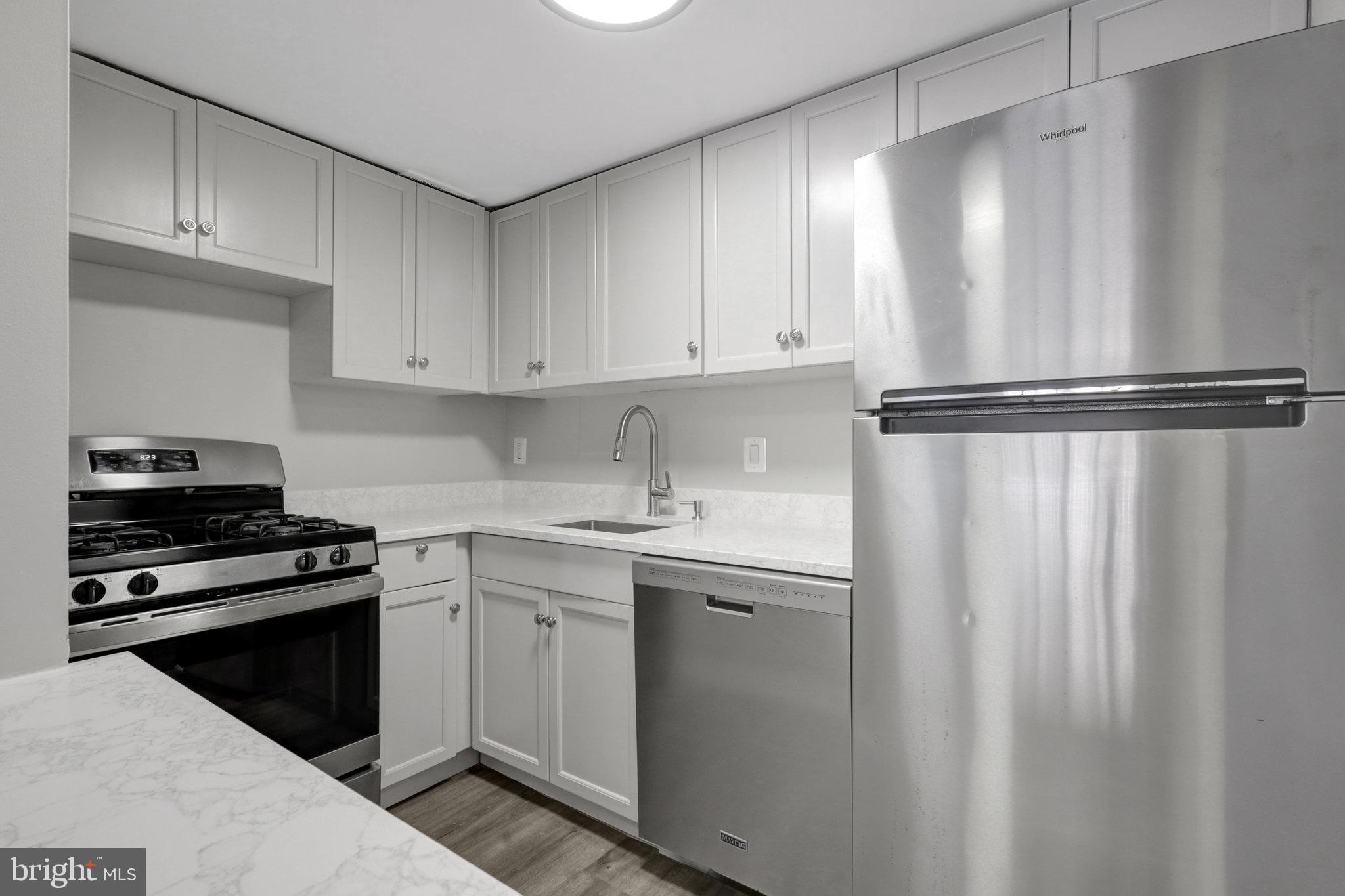 Stunning, fully renovated ground level (from parking lot) unit! As convenient as a unit here gets! Kitchen and bath remodeled, all lighting, plumbing and electrical replaced! Don't lift a finger and move right it or list for rent immediately. Tons of parking, all unassigned, and parking lot entrance to the building is conveniently around the corner from the unit. Never need to use an elevator! Agent is owner.