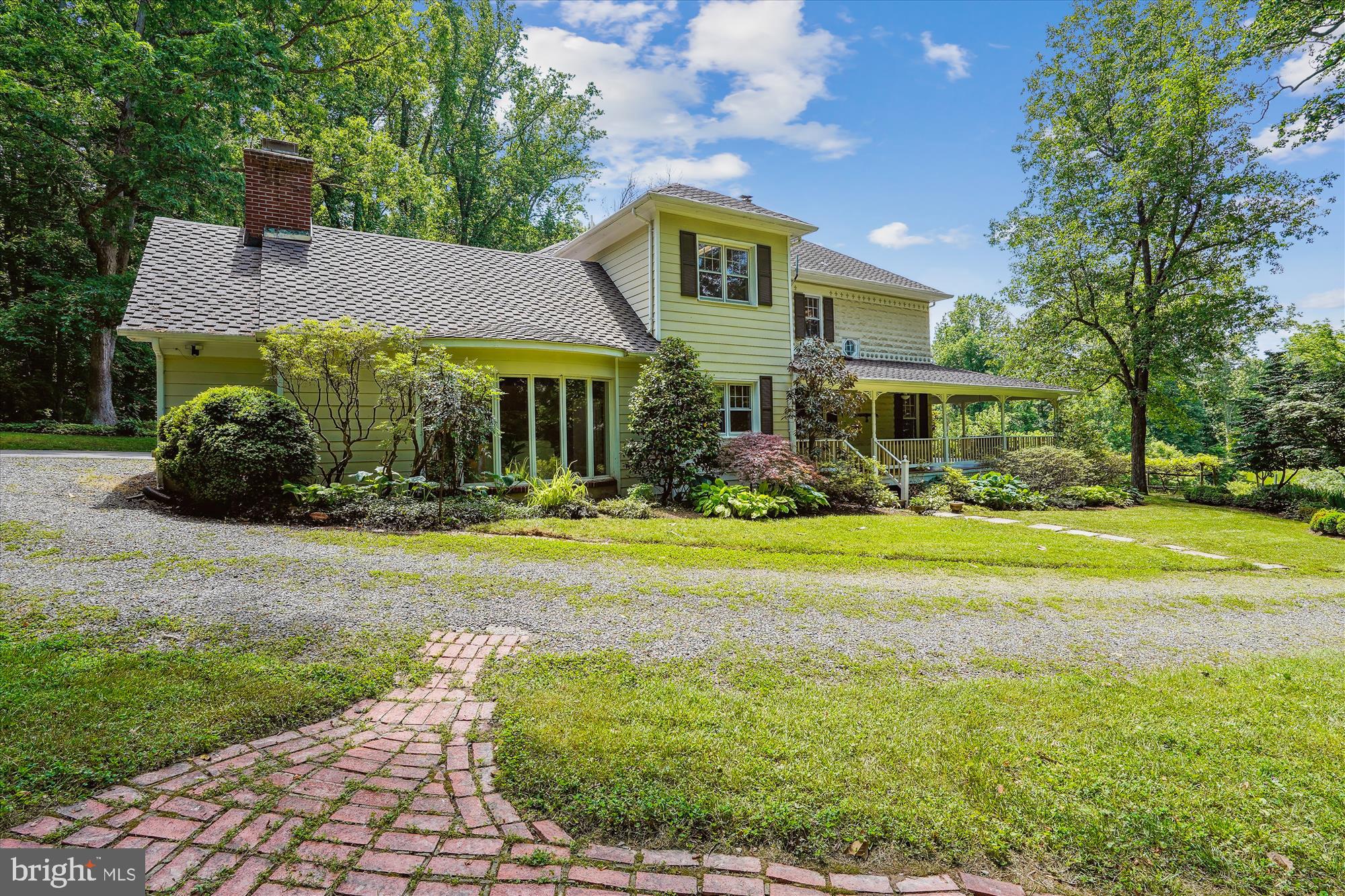 ******OPEN SUNDAY   June 16   1-3 PM.   ********Sited high on 2.07 acres adjacent to Great Falls Park land, this distinguished estate comprises a total of 5 BEDROOMS and 5 BATHROOMS, thoughtfully distributed across the main house, a charming separate COTTAGE and a STUDIO nestled above the 2-car garage. The original 1909 main residence, seamlessly expanded over time, features 3 bedrooms and 3 full baths with a family room and country chef's kitchen addition.  The residence has a wrap-around porch and a custom gourmet kitchen adorned with handcrafted cabinets by skilled craftsmen from a religious sect. Inside, a welcoming family room awaits anchored by a massive stone woodburning fireplace which will take a 5-log,  a wood plank cathedral ceiling, and a bay window offering serene views of the lush surroundings. 

Once in a lifetime opportunity.  Adding to the allure of this property are the additional living spaces—a cozy cottage boasting 1 bedroom and 1 full bath, wood burning fireplace, full kitchen & laundry, perfect for accommodating guests, MIL suite or as a private retreat.   A studio above the garage offering another independent space w/1 bedroom and 1 full bath, full kitchen & laundry, ideal for a nanny, MIL, home office or creative sanctuary with skylights perfect for artist studio.   Each space is thoughtfully designed to provide privacy, comfort and functionality, ensuring a seamless blend of form and function throughout the property.

This estate offers both tranquility and convenience, presenting a once-in-a-lifetime opportunity to own a piece of Great Falls history.  Nestled in the heart of Great Falls, Virginia, this home exudes timeless charm and historical significance. Local lore suggests it may be an original Sears Catalog  home, constructed in 1909 of concrete block w/fleur-de-lis adorned trim.    

Outside, the landscape is a true delight, with hardscaping enhancing outdoor living areas and hundreds of flowering bulbs, flowers, shrubs ensuring year-round beauty.  Red Maple trees, oaks, walnut and magnolia trees planted throughout the property. Parkland property is totally wooded and provides trails to walk to the beautiful Great Falls.    A long gardens write-up will be available for viewing at your visit to this property.  Whether you seek a primary residence or a weekend retreat, this property embodies the essence of country living in one of Virginia's most sought-after locales.
Walk to the Potomac River!    Great Falls Village Center is 2 miles, easy, direct access to 495 on Georgetown Pike, a historic byway.