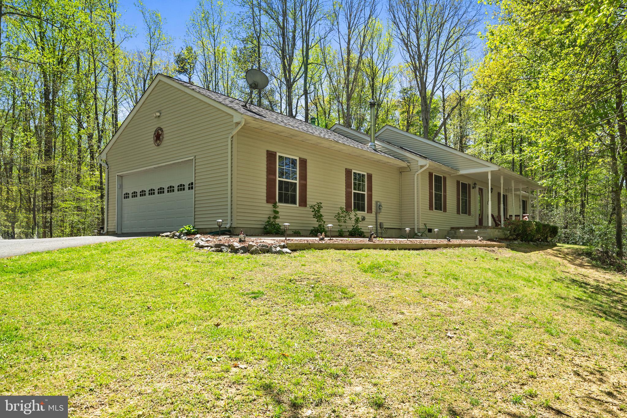 Welcome to this beautifully maintained 3 bedroom, 2.5 bath rambler nestled on over 3.5 private acres with no HOA! Enjoy a spacious and updated kitchen featuring stainless steel appliances, a center island, and plenty of cabinet space, perfect for the cook at home. Entertain in the formal dining room or relax in the cozy family room with vaulted ceilings, skylights and wood stove. The home offers a desirable one-level layout, a 2-car attached garage, plus a separate shed for additional storage or workshop space. Step outside to a peaceful setting with a welcoming front porch, a multi-level rear deck perfect for gatherings, and a level backyard that backs to mature woods for added privacy. Don’t miss this rare blend of comfort, convenience, and seclusion—schedule your tour today! Updates include roof (2021), water heater (2019), heat pump (2022), and skylights.