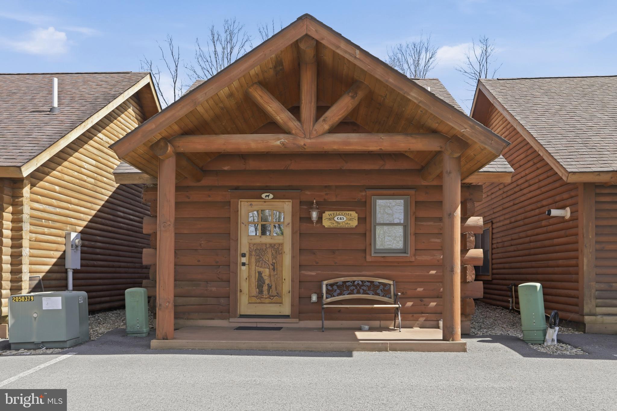 BOAT SLIPS! LAKE ACCESS & VIEWS! 4TH OF JULY FIREWORKS VIEWS! SKI SLOPE VIEWS! Cabin #43 at The Lodges of Sunset Village is a detached efficiency unit with a living room with a sleeper sofa, 2 queen beds, a full bath, kitchenette and approximately 576 square feet, fully furnished and turnkey. This unit has a porch & patio too! 

Rich in mountain character and charm, this log cabin features uniquely carved wooden doors, beautiful beamed ceilings, warm wood walls, and inviting spaces that create an authentic lake-and-mountain retreat feel. Additional features include lake and ski slope views, expansive decks, upgraded finishes, open-concept living, a stacked-stone gas fireplace. Enjoy incredible views of Deep Creek Lake and Wisp, along with front row seats for seasonal beauty and memorable moments, including views of the annual July 4th fireworks. 

This property has a proven rental history, generating an average of  $33,213  in annual gross
rental income creating an exciting opportunity for
buyers seeking both personal enjoyment and investment potential. Experience one of Deep Creek Lake’s
newest ownership opportunities at The Lodges at Sunset Village. For the first time ever, fully furnished lake
area cabins are being offered for individual ownership in a breathtaking community featuring incredible lake
and Wisp ski slope views. Community amenities include lake access with 10 shared dock slips and an
impressive 1,320 square foot waterfront dock area perfect for fishing, swimming, launching kayaks,
relaxing by the water, and enjoying summer fun at the lake. Residents and guests also enjoy a lakeside
gazebo, playground, fire pit, gathering areas, pet-friendly accommodations, abundant parking, and on-site
professional management. The monthly condo fee provides exceptional convenience, including most
utilities, snow removal, trash service, and yard maintenance, for a low-maintenance ownership experience. Whether you're searching for a vacation retreat, income-producing investment, or both, The Lodges at
Sunset Village offers a rare opportunity to own at Deep Creek Lake. Call today for your private showing!
