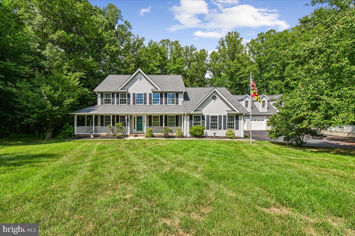 Tucked away at the end of a peaceful cul-de-sac in the highly sought-after Swanson Creek Landing community, this colonial is perfectly situated on 4.4 picturesque acres with a blend of open lawn and mature woods. A winding path leads to a charming bridge and tranquil creek—creating your own backyard retreat. Designed for both everyday living and entertaining, the home features a wraparound porch, a spacious deck, hardwood floors throughout the main level, an updated primary bath with a freestanding soaking tub, and a finished walk-out basement complete with a recreation room, bonus room, full bath, storage, and potential fifth bedroom. Recent improvements include a new roof (2023), HVAC (2022),  a beautiful sliding glass door that allows a ton of light into the kitchen, and a newly paved driveway.
With an attached two-car garage, a detached two-car garage with workshop above, chicken coop, multiple outbuildings, and no HOA, there is plenty of room for hobbies, storage, and outdoor living.  Conveniently located with easy access to Joint Base Andrews, Washington, D.C., Northern Virginia, Metro, commuter park-and-ride lots, and major commuter routes. Outdoor enthusiasts will also appreciate nearby Benedict Community Park, which offers public access to the Patuxent River for fishing, kayaking, and a boat launch. For equestrian enthusiasts,  Maxwell Hall Equestrian Park has over 14 miles of publicly owned equestrian trails.