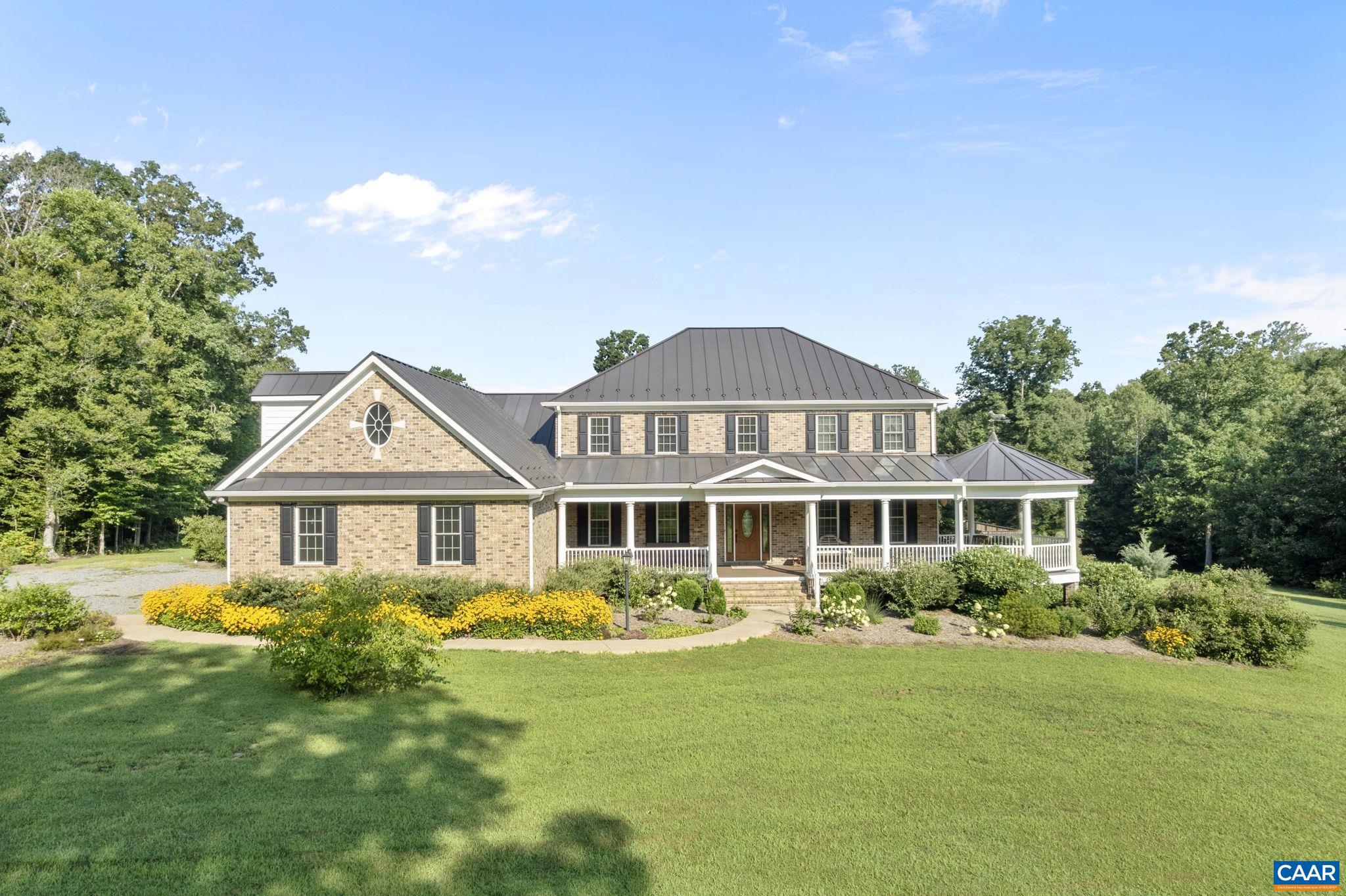 Standout estate featuring privacy, acreage, hobby farm potential, and close proximity to Lake Anna and local shopping. The home is a modern four-bedroom farmhouse with an all brick exterior, a metal roof, hardwood and ceramic floors, a gourmet kitchen, two master bedroom suites, a three-car garage, and a large veranda with a gazebo. The estate also features an 18? saltwater pool, a large gravel parking area, a large metal storage building with power, and other outbuildings. The home combines traditional historical elements such as bead board ceilings, wainscoting, glass door knobs, and traditional wooden railings and balustrades with modern amenities such as granite countertops, a gas fireplace, a gas stove top, double oven, conditioned crawlspace, a walk-in attic, and high speed internet. Privacy is assured because the house is situated well off the road in the middle of 86 acres of mature mixed hardwoods. The home is located in a large clearing providing excellent views of the rolling land, extensive flower beds, and ornamental trees. The surrounding hardwoods feature running streams, wildflowers, and wildlife, including deer, turkey, and small game. Trails run through the hardwood providing access to the wooded areas.,Cherry Cabinets,Granite Counter,Fireplace in Family Room