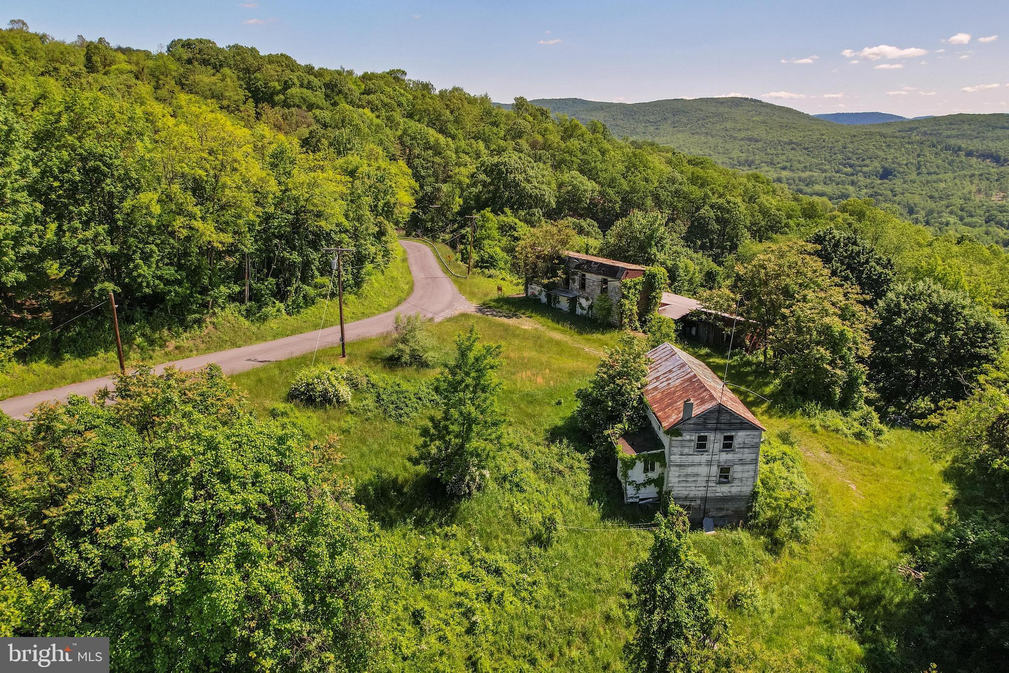 This expansive 241.87+/- acre property, located just outside the historic city of Cumberland, Maryland, offers a rare and versatile opportunity for investors, developers, and outdoor enthusiasts alike. Recently updated to include an additional 6+/- acres (highlighted on the aerial map within the purple boundary), this massive tract now provides even more room for exploration and planning. The property is currently undergoing a formal subdivision process; while the 241.87+/- acre figure is an estimate, the approximate boundaries are clearly identified on the map by a dashed yellow line, showcasing the sheer scale of the land.

Once a thriving orchard, the landscape has matured into a predominantly mature wooded sanctuary. A serene creek meanders through the lower elevations, creating a picturesque setting that feels worlds away from the hustle and bustle. The diverse topography and dense cover make it a magnet for local wildlife, with an incredible abundance of whitetail deer frequently spotted across the acreage. Whether you are a dedicated hunter or a nature lover, this property offers a private ecosystem that is hard to replicate.

Accessibility is a major highlight, with over half a mile of road frontage providing easy entry and significant potential for further subdivision. While the existing farmhouse and barn are currently in a non-habitable state, they offer a nostalgic footprint for those interested in restoration projects or repurposing historic materials.

Despite its profound privacy, the property is strategically located near essential amenities. UPMC Western Maryland is only 3.5 miles away, and the entertainment of Rocky Gap Casino, Resort & Golf is a short 8-mile drive. This property perfectly balances the tranquility of a mountain retreat with the utility of future land development. Connect with Land Specialist Taylor Nitterhouse today to schedule your private tour.