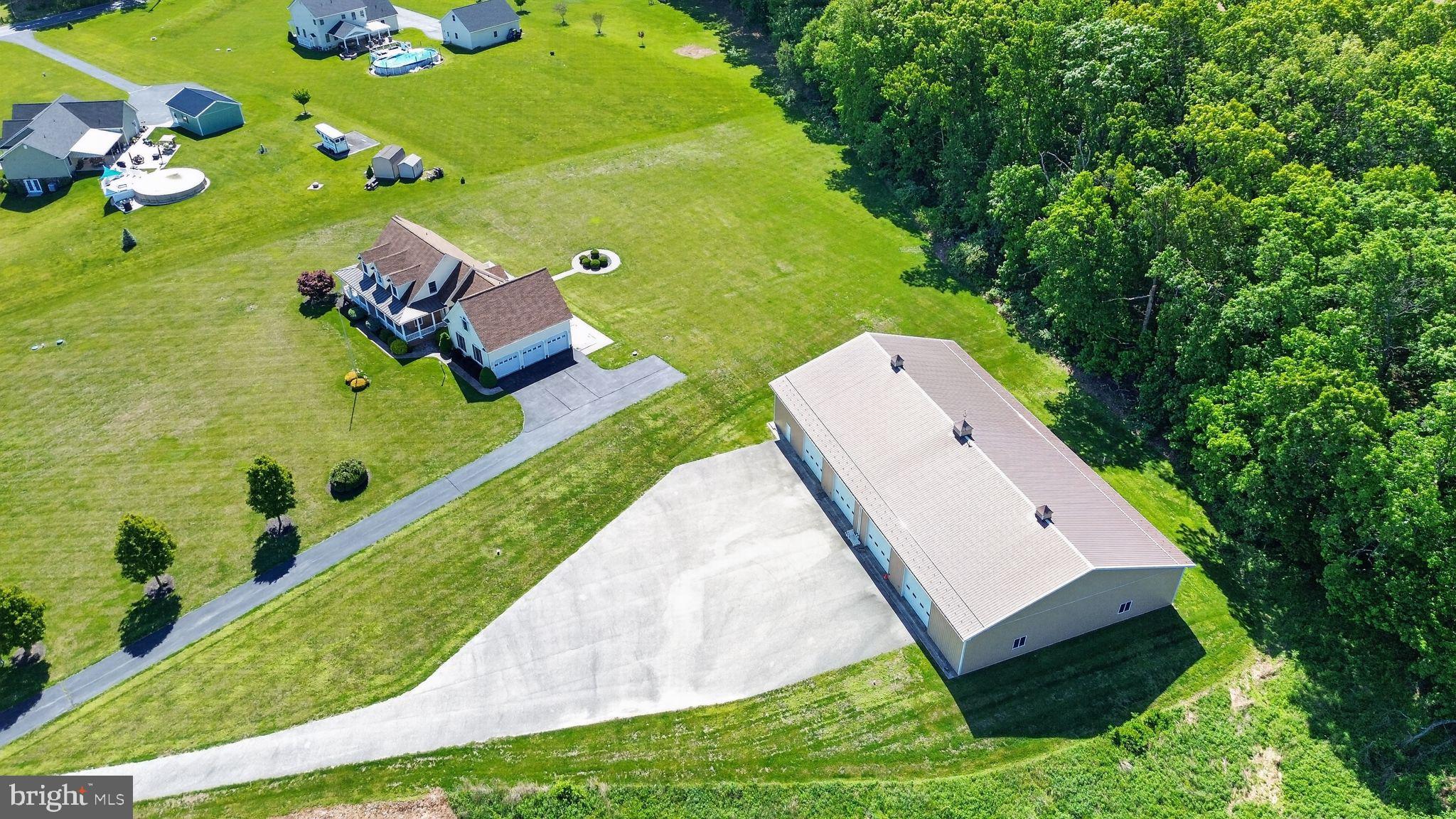 Nestled among picturesque farmland and offering the perfect balance of peace, privacy, and convenience, this extraordinary custom home at 1165 Line Rd in Westminster is a rare opportunity to own a property that truly has it all. Just 15 minutes from downtown Westminster, this stunning estate combines luxurious living with unmatched versatility and endless potential.

Boasting 4 bedrooms and 4.5 bathrooms, the home welcomes you with soaring vaulted ceilings, expansive windows, and an abundance of natural light that fills every corner. The heart of the home is the beautifully designed open-concept kitchen and living area, where a cozy gas fireplace creates the perfect gathering space for everyday living and entertaining alike. The updated gourmet kitchen features beautiful cabinetry, granite countertops, and top-of-the-line stainless steel JennAir appliances, seamlessly blending style, function, and luxury. The spacious layout flows effortlessly into the living room, creating the ideal setting for entertaining or everyday comfort. A formal dining room offers ample room for large holiday dinners, celebrations, and memorable gatherings.

The main-level primary suite is a private retreat featuring breathtaking views, a spacious walk-in closet, and a spa-inspired bathroom complete with a large soaking tub designed for relaxation. A dedicated main-level study provides additional flexibility and can easily serve as a guest bedroom, home office, or library.

Upstairs, you’ll find two generously sized bedrooms, each with its own private full bathroom, creating comfort and privacy for family or guests. An oversized fully finished bonus/recreation room offers endless possibilities — use it as an additional bedroom, gaming room, home gym, gymnastics or dance studio, bunk room, media room, creative space, playroom, or executive office. The flexibility of this home is truly unmatched.

The fully finished walkout basement is designed for entertaining and enjoyment, featuring a custom-built bar with upgraded cabinetry, open shelving, and impressive finishes throughout. The pool table conveys with the home, making this the ultimate ready-made entertainment space. A gas fireplace adds warmth and ambiance, while the expansive recreation areas and full bathroom create limitless options for hosting, relaxing, or multi-generational living.

Car enthusiasts and hobbyists will appreciate the fully finished and insulated attached three-car garage, while outside, the possibilities continue. Step onto the rear deck overlooking the level backyard, where an area has already been graded and prepared for a future pool installation.

One of the property’s most remarkable features is the massive 8,400-square-foot detached garage/shop building — a dream space with incredible income and lifestyle potential. Whether you envision a private sports training facility, contractor headquarters, automotive workshop, collector car storage, RV or boat storage business, event space, fitness facility, woodworking shop, creative studio, warehouse, rental income opportunity, indoor recreation area, equipment storage, agricultural use, or future conversion possibilities, this extraordinary structure offers opportunities that are nearly impossible to find.

Surrounded by scenic countryside yet conveniently located near shopping, dining, and commuter routes, this exceptional property delivers luxury, flexibility, and opportunity in one unforgettable package.