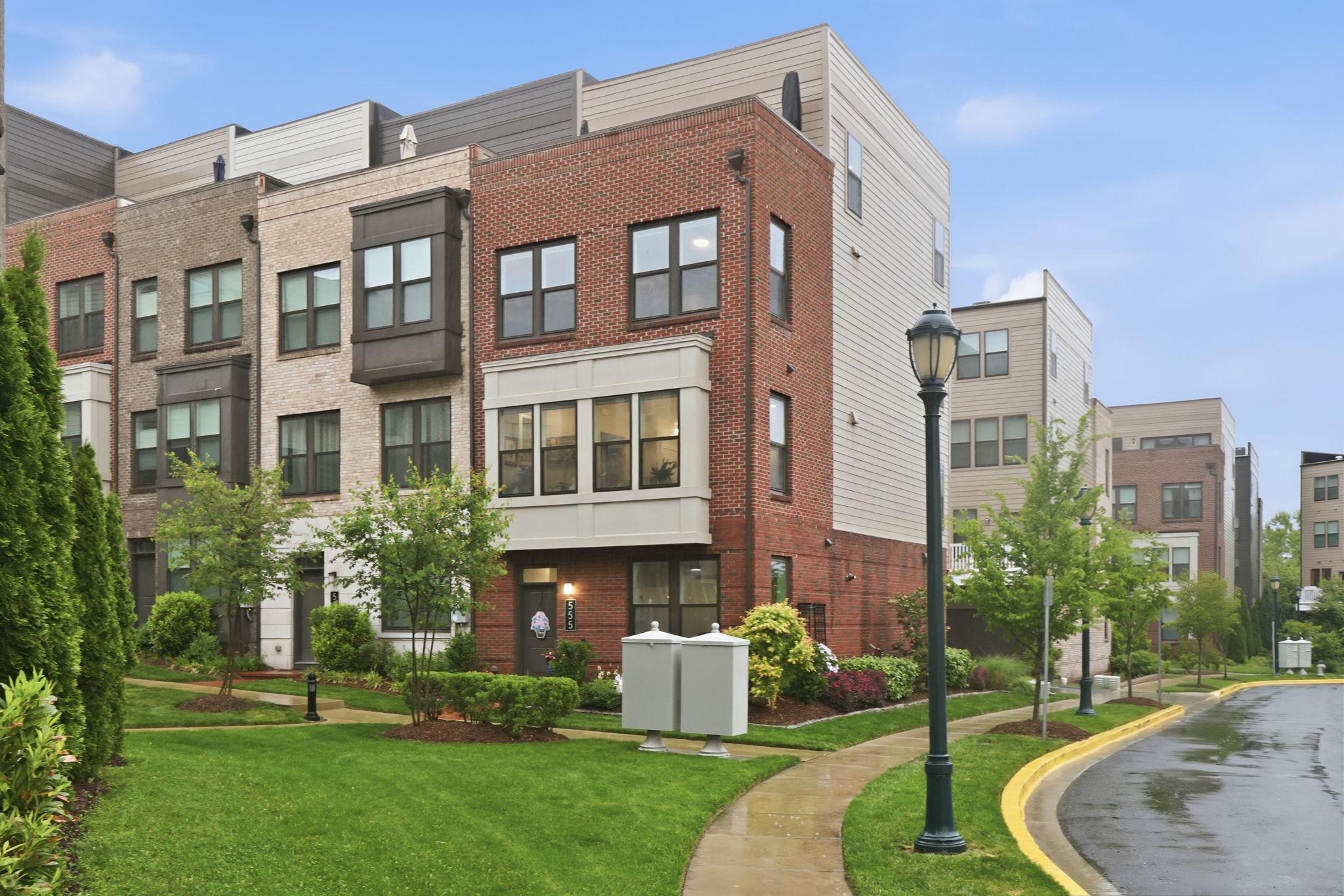 Get ready to be impressed. Better-than-new end-unit townhome, built in 2020, offering luxury living with thoughtful designer upgrades throughout. Beautifully positioned with professionally designed landscaping, this one-of-a-kind, sunny and light-filled home blends warmth, style, and modern functionality. Features include reclaimed wood salvaged from Maryland barns, wide-plank engineered hickory hardwood flooring, custom Benjamin Moore paint, upgraded fixtures, and Pottery Barn lighting.

Enter on the first level, where you’ll find a private bedroom—perfect for guests, a gym, or home office. This level also includes a tiled storage room with rough-in plumbing already in place for a future full bath. The garage is finished with an epoxy floor and ceiling-mounted storage.

Upstairs, the main living level was designed for entertaining and everyday luxury. The chef’s kitchen features quartz countertops, an oversized island, double-wide pantry, wine bar with beverage refrigerator, commercial-grade 6-burner gas range, wall oven, and convection microwave. The adjoining living area showcases a dramatic reclaimed wood accent wall, while a convenient powder room completes the level.

The third floor offers two spacious bedroom suites, each large enough for a king-size bed. Enjoy ample storage with custom walk-in closets and an upgraded bath with custom shelving, mirrors, and a spa-style glass barn-door shower enclosure.

The top level offers a bright loft space with custom cherry wood industrial shelving, ideal for a home office, lounge, or library, along with an additional bedroom suite for guests or flexible living. Step outside to the rooftop patio lounge—perfect for relaxing or entertaining under the stars.

Enjoy all that King Farm has to offer, including neighborhood pools, parks, playgrounds, scenic walking trails, village shopping and dining, community events, and a convenient shuttle to Shady Grove Metro. Ideally located near I-270, ICC, and major commuter routes, King Farm remains one of the area’s most sought-after communities for lifestyle and convenience.

This is not a builder-basic home—it is a carefully curated residence that lets you live in comfort, style, and luxury.
